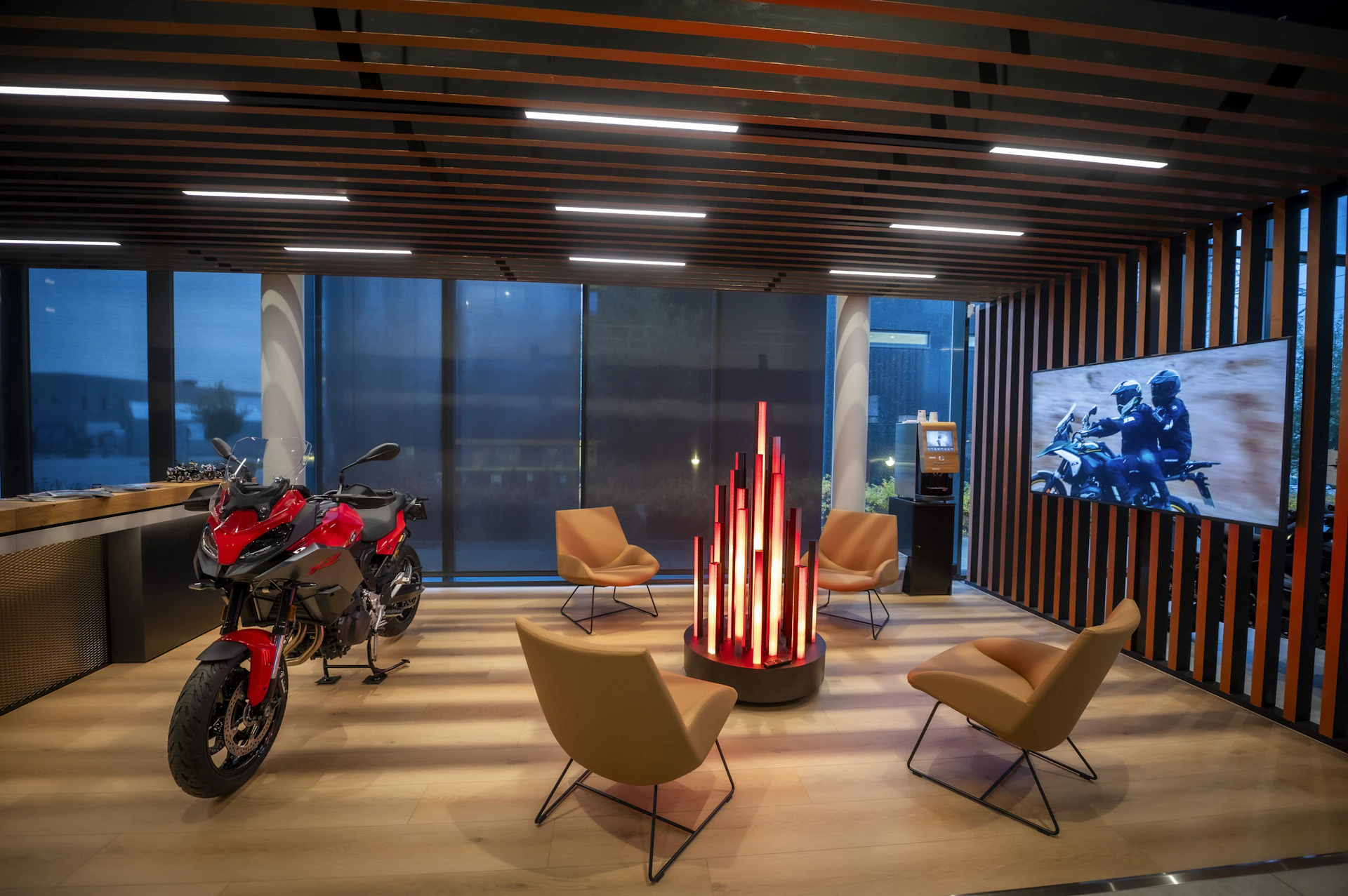 Modern lounge with red motorcycle and fireplace