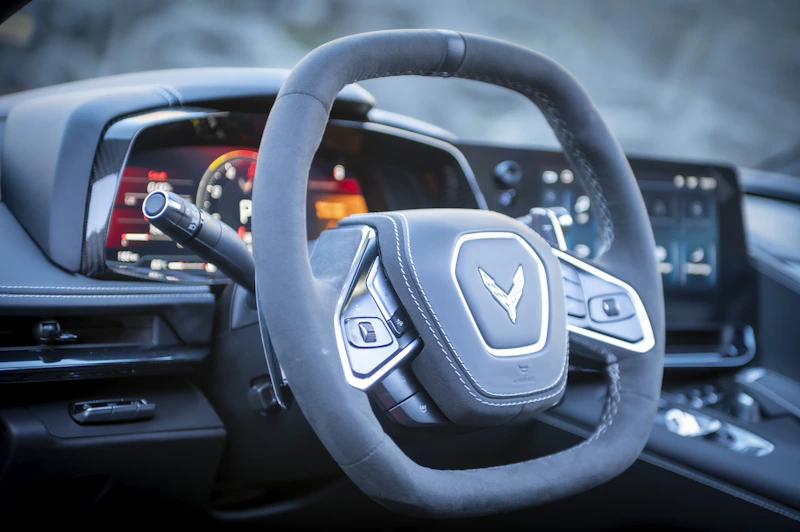 Close-up of a modern car's steering wheel and dashboard.
