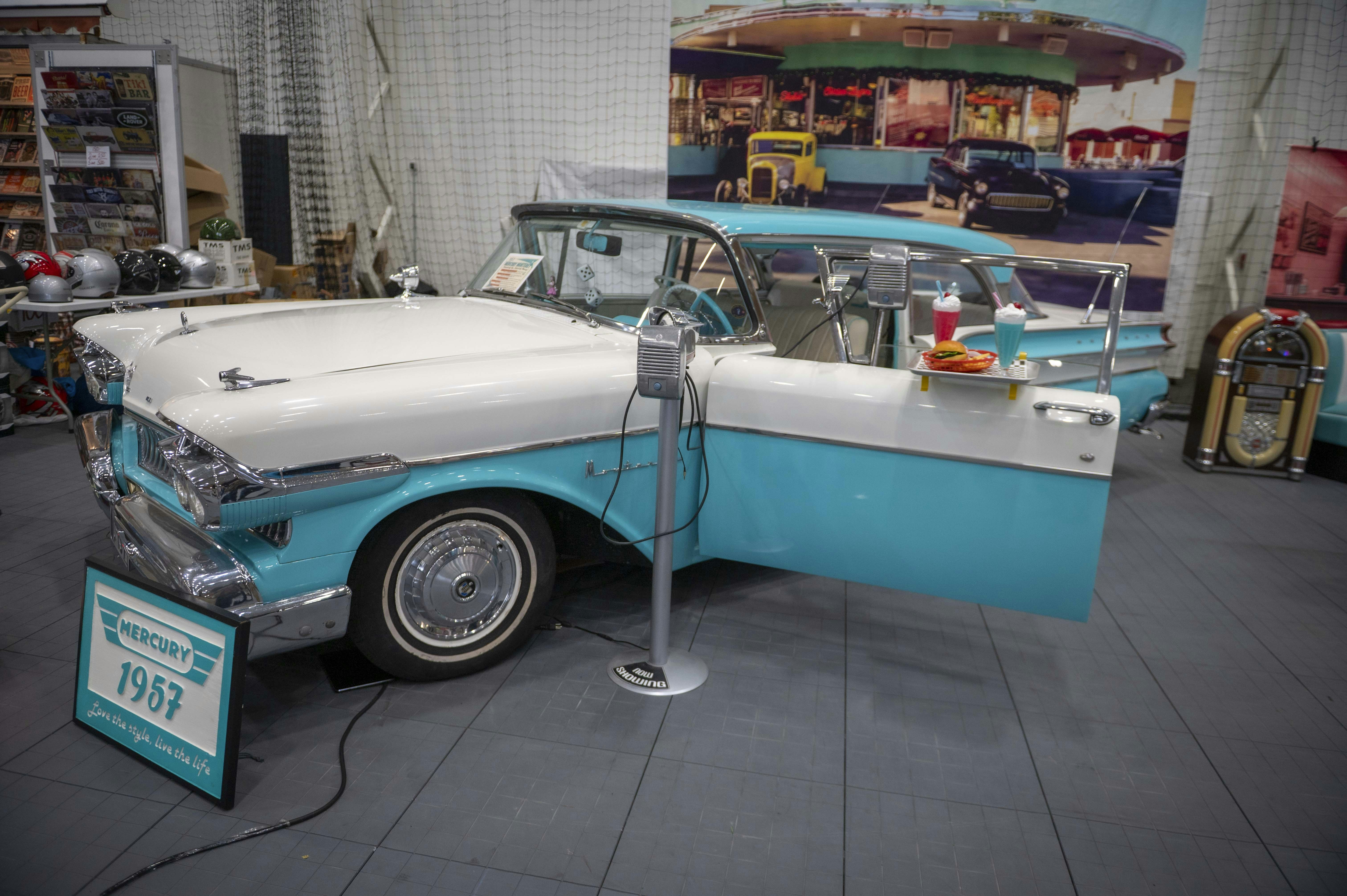 Vintage turquoise and white car with open door