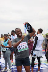 Man proudly shows off his race medal after a run.
