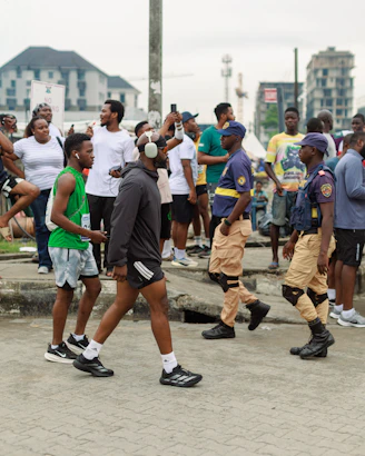 People gathered for an outdoor event with security personnel present