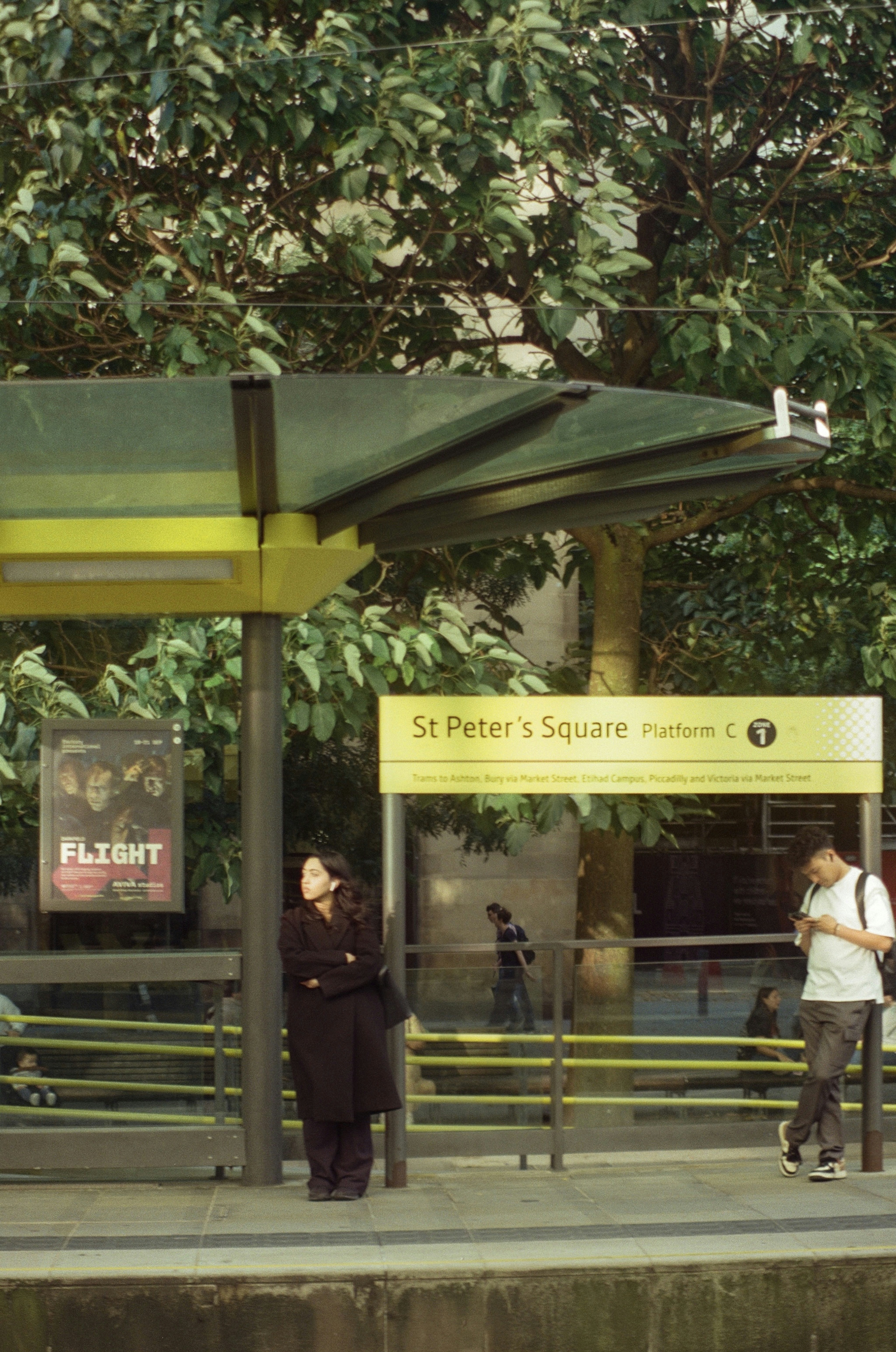 People wait at a st peter's square tram stop.