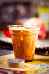 Iced coffee in a clear plastic cup with ice.