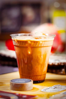 Iced coffee in a clear plastic cup with ice.