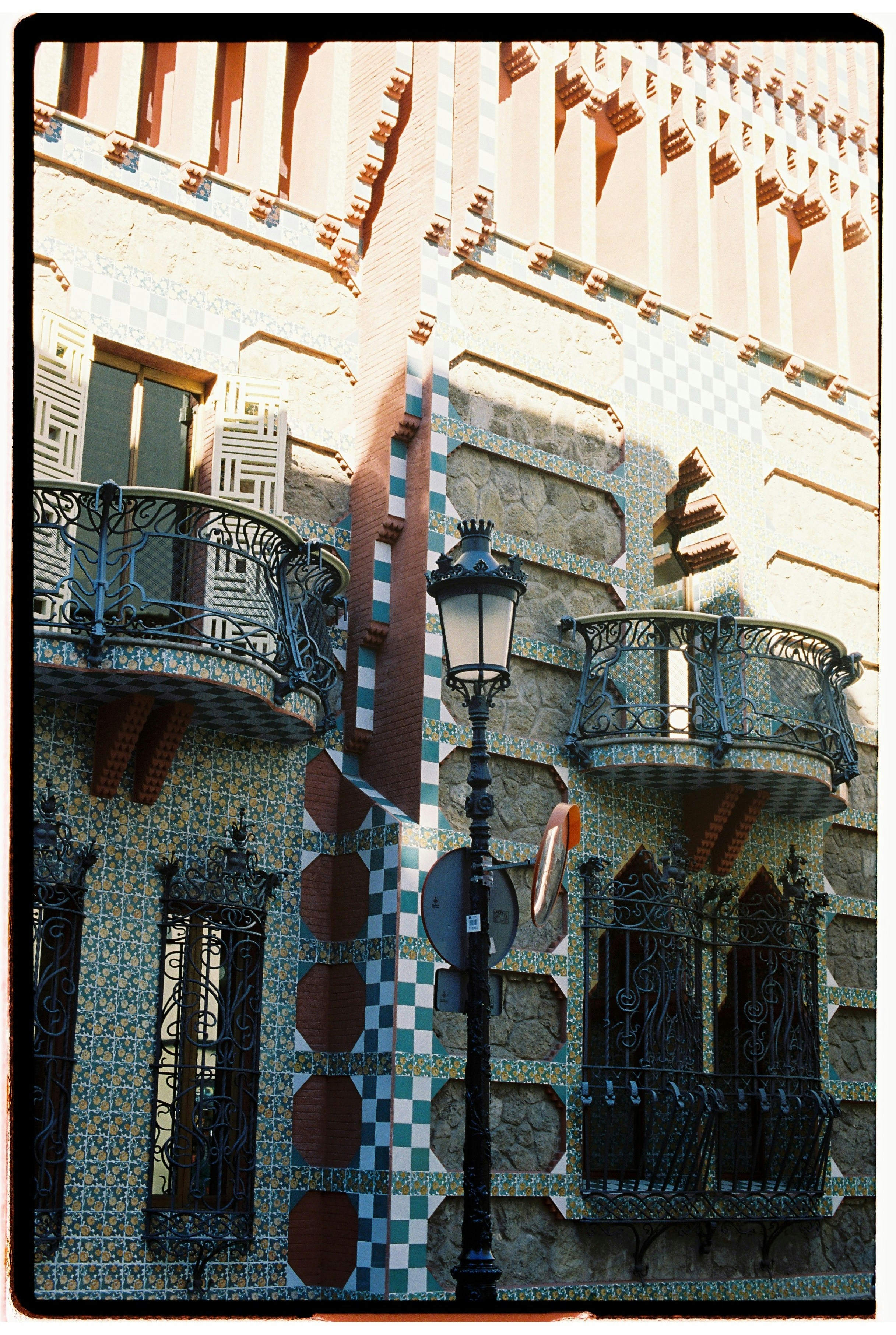 Ornate building facade with balconies and lamp post
