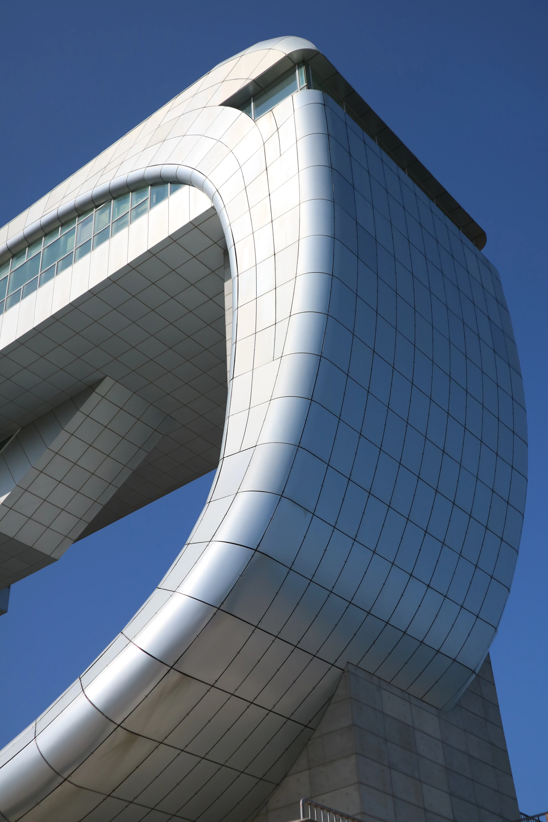 Modern architectural building with curved metallic facade