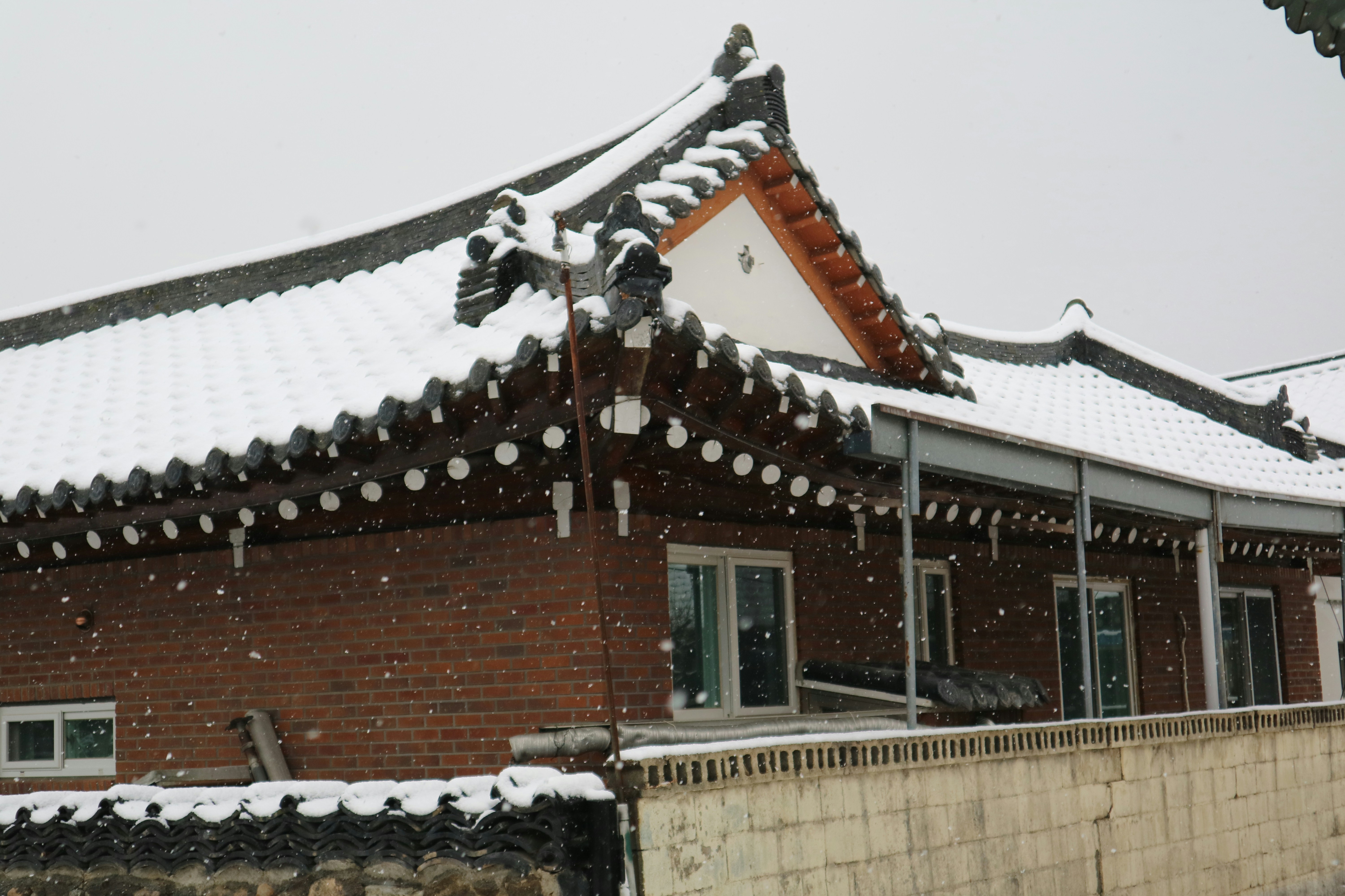 Traditional korean house roof covered in snow.