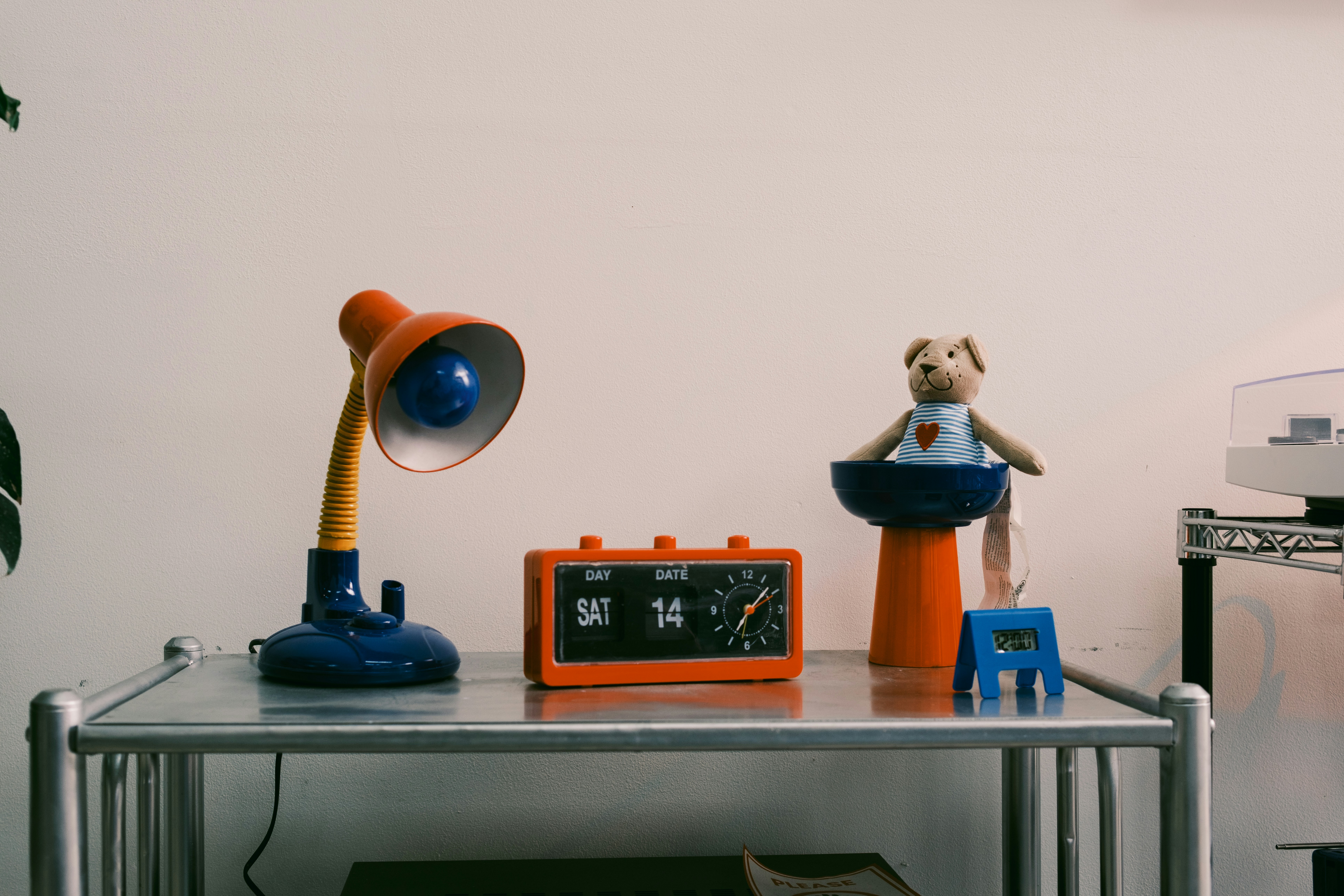 Desk with lamp, clock, and teddy bear