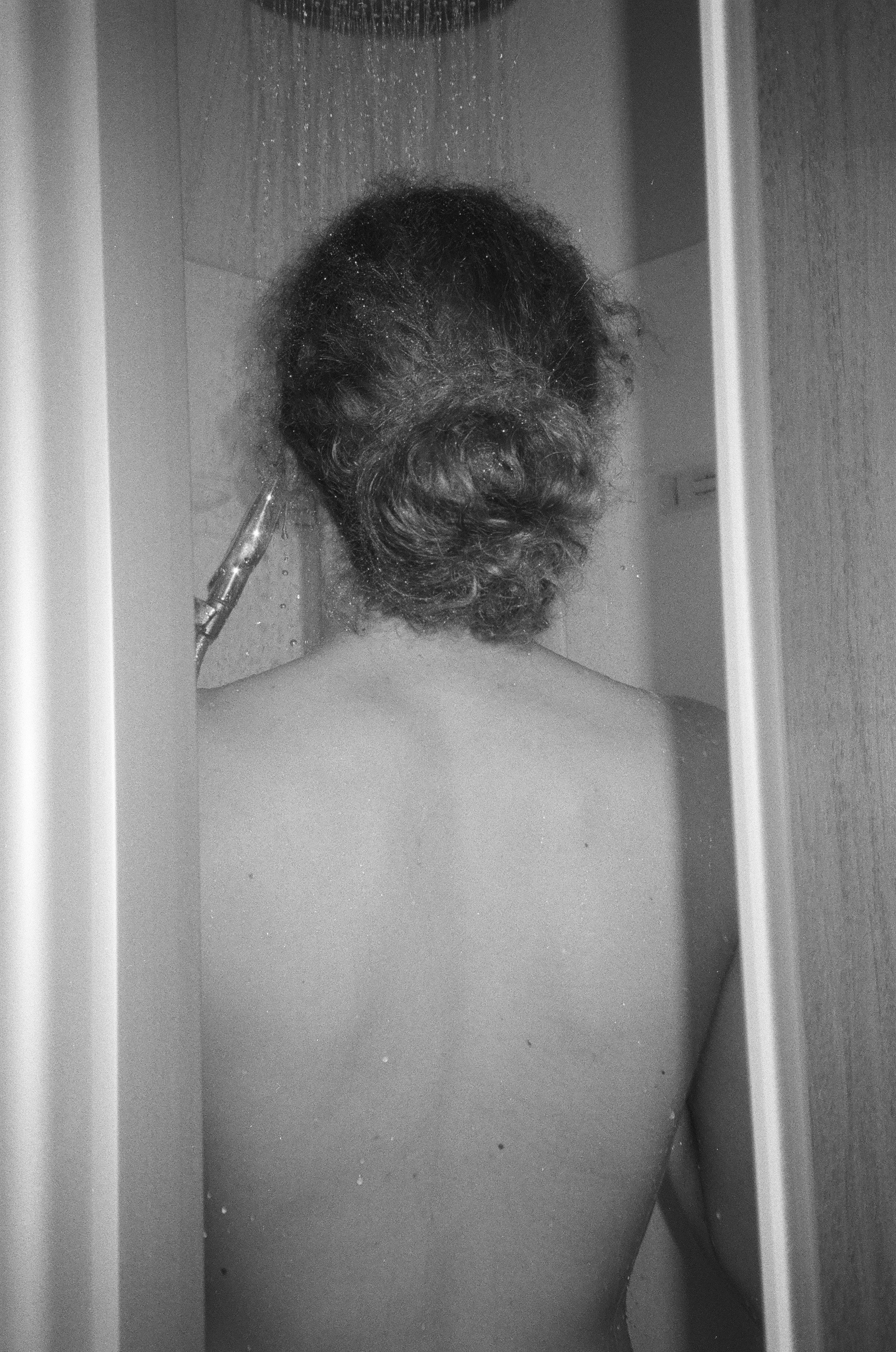 Person showering with water cascading down
