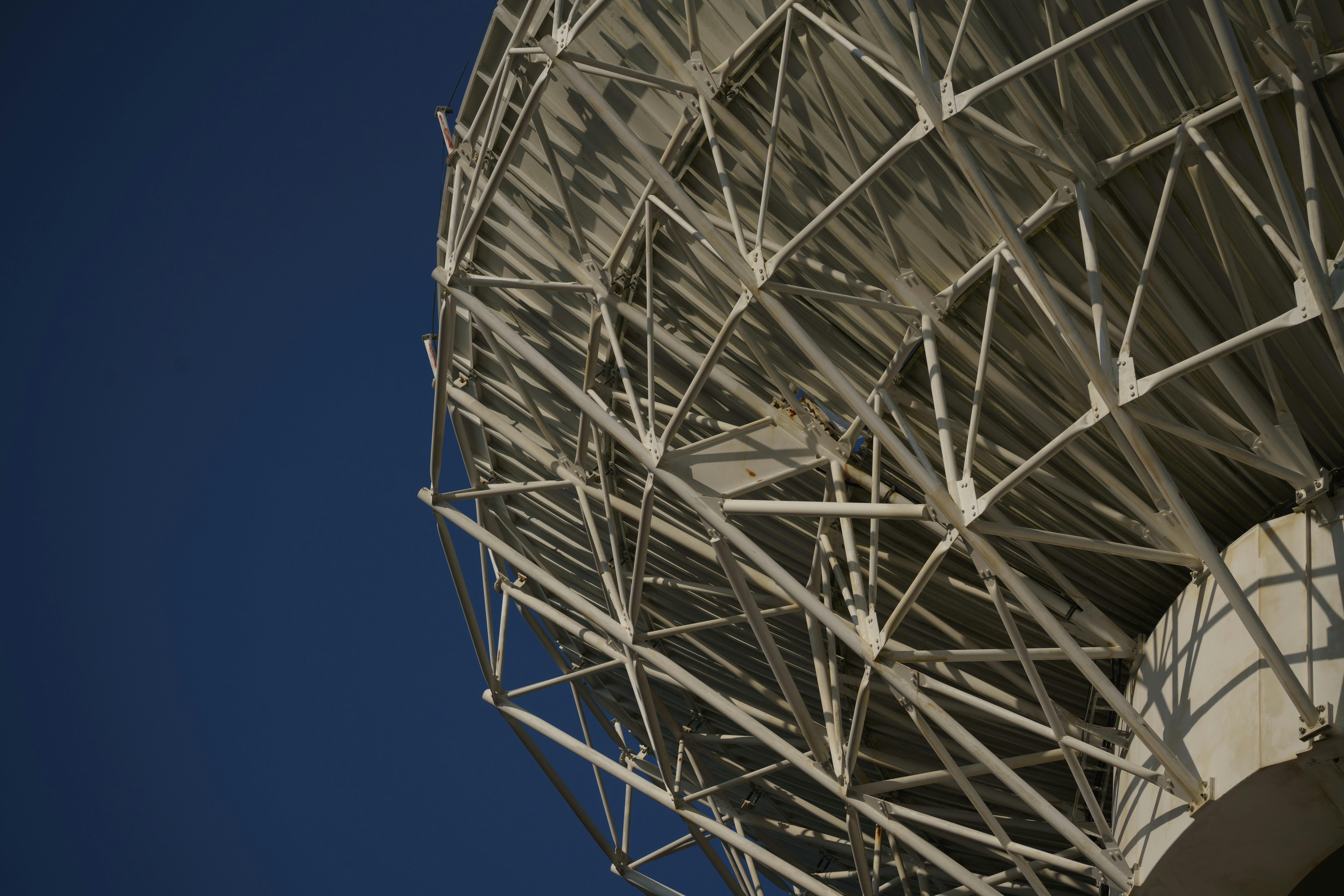 White metal structure against a clear blue sky