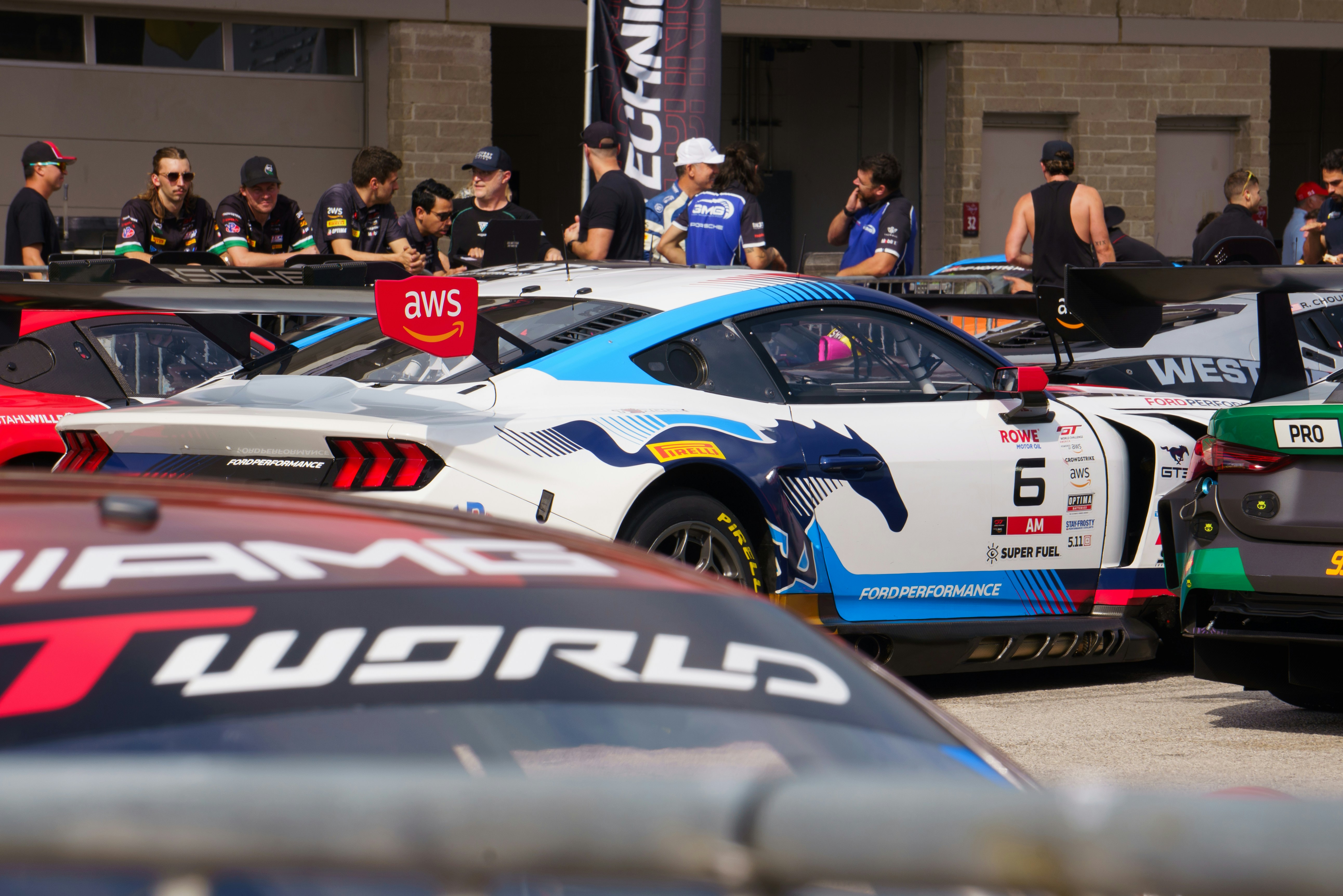Race cars and pit crew at a track event photo – Free Sports car Image ...