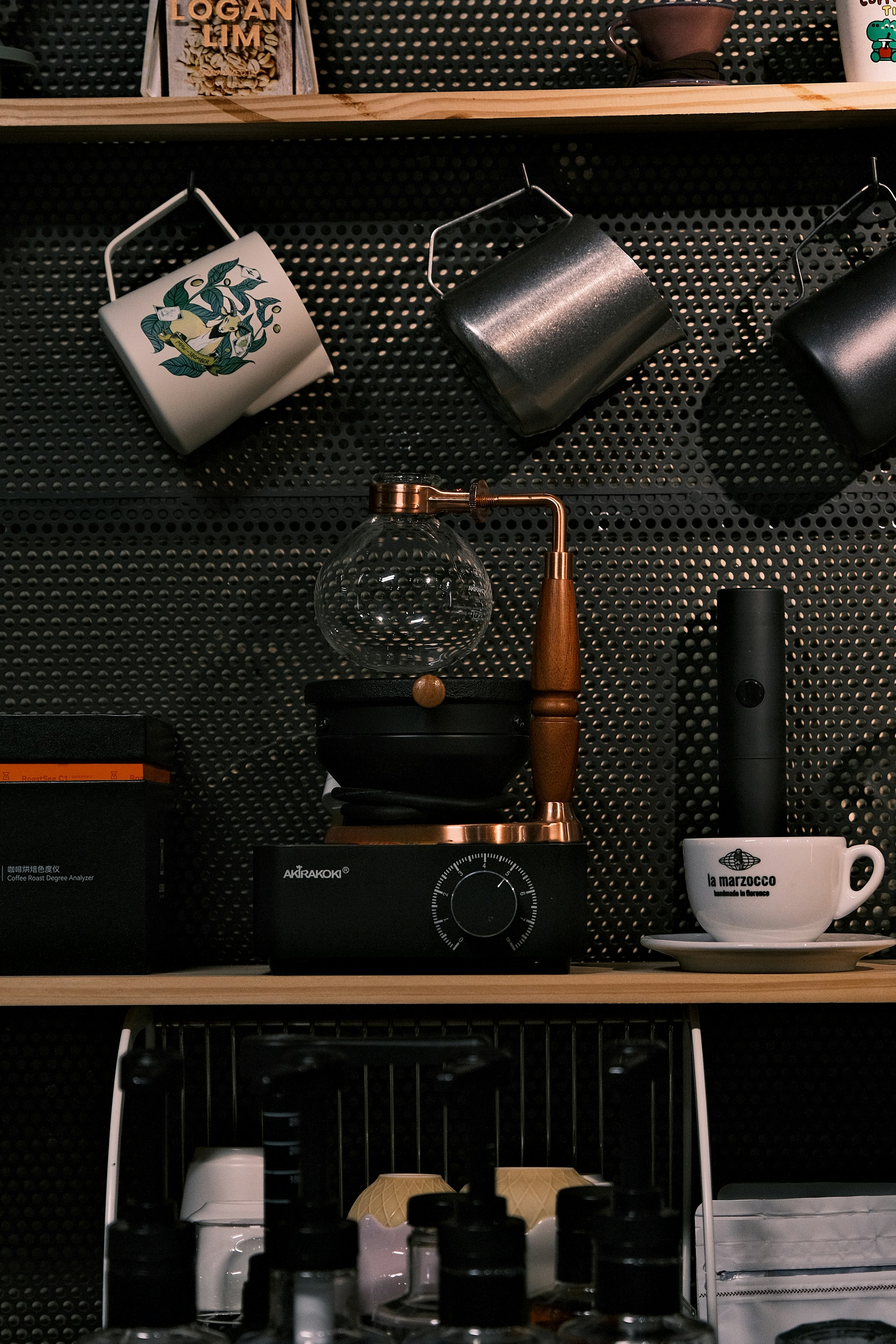 Coffee maker and mugs on a shelf