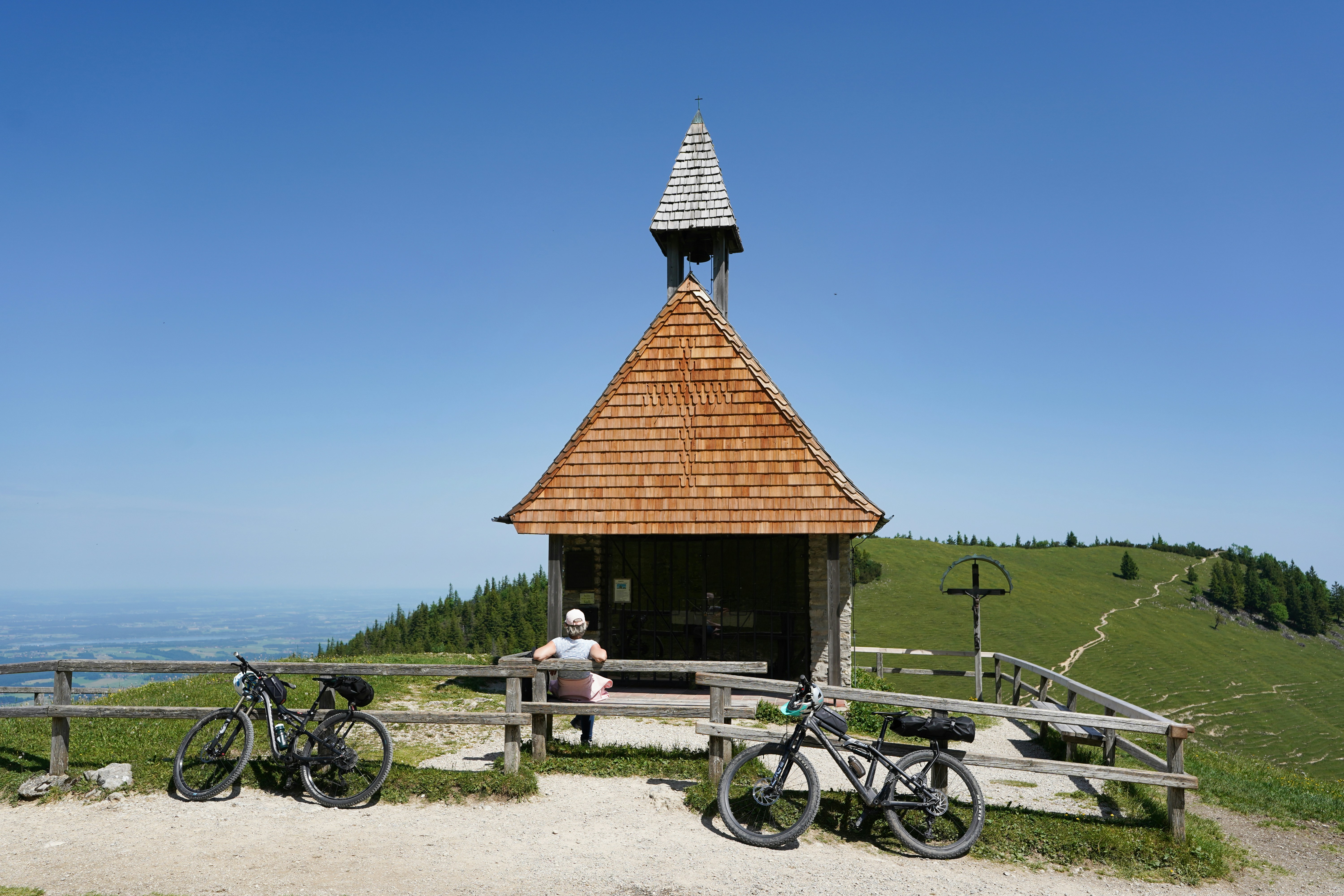Small wooden chapel on a mountain with bicycles
