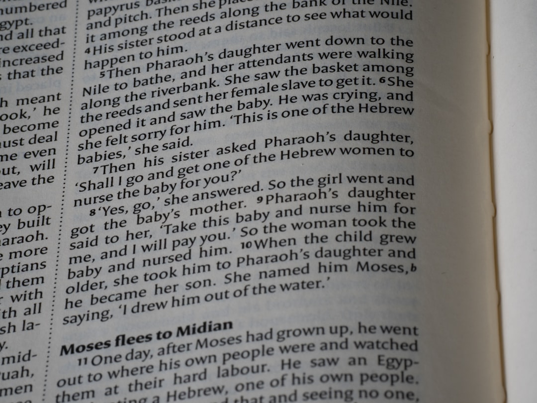 Close-up of an open bible with text visible.