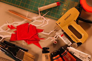 Crafting supplies including scissors, paint, and stapler.