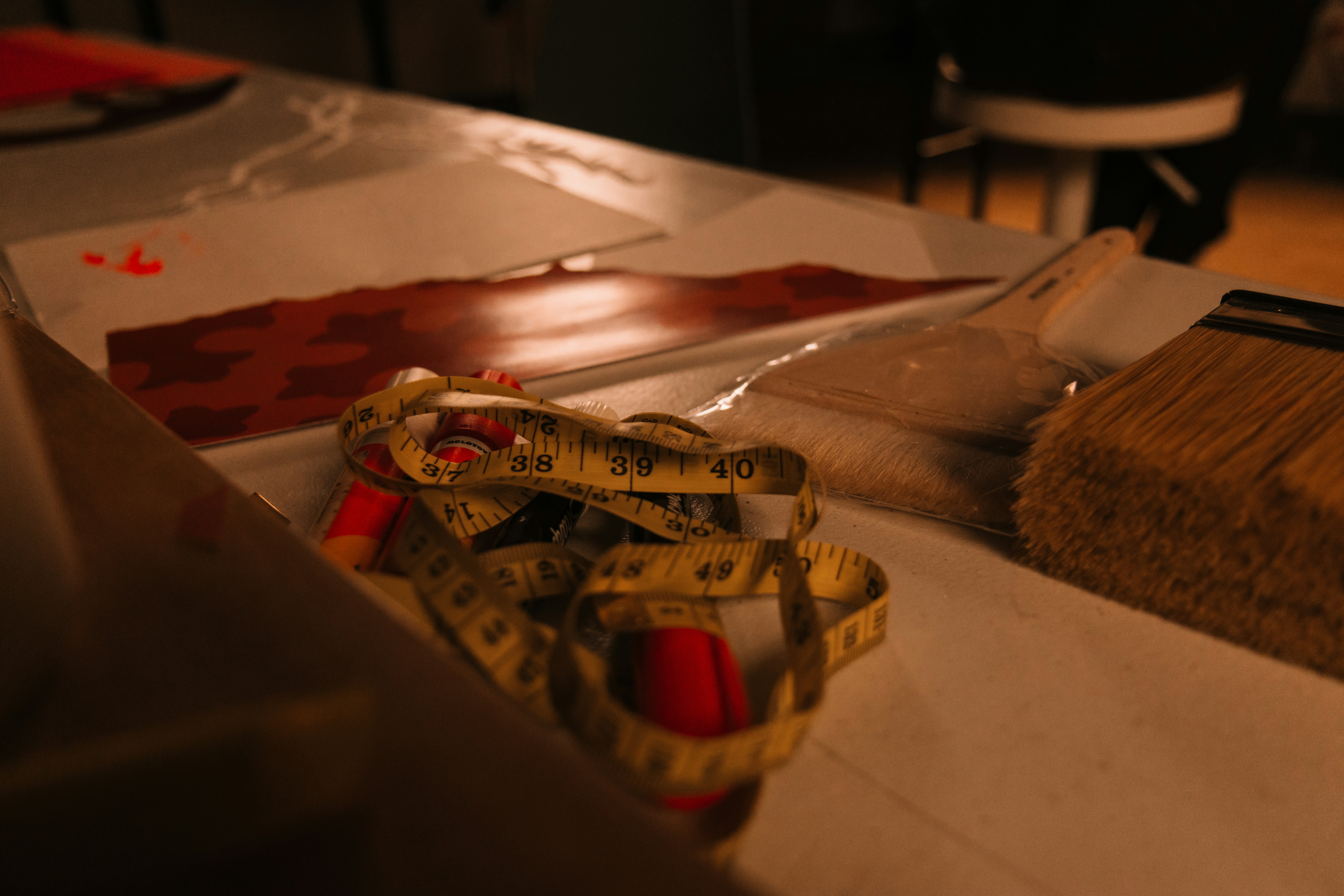 Measuring tape and brush on a crafting table