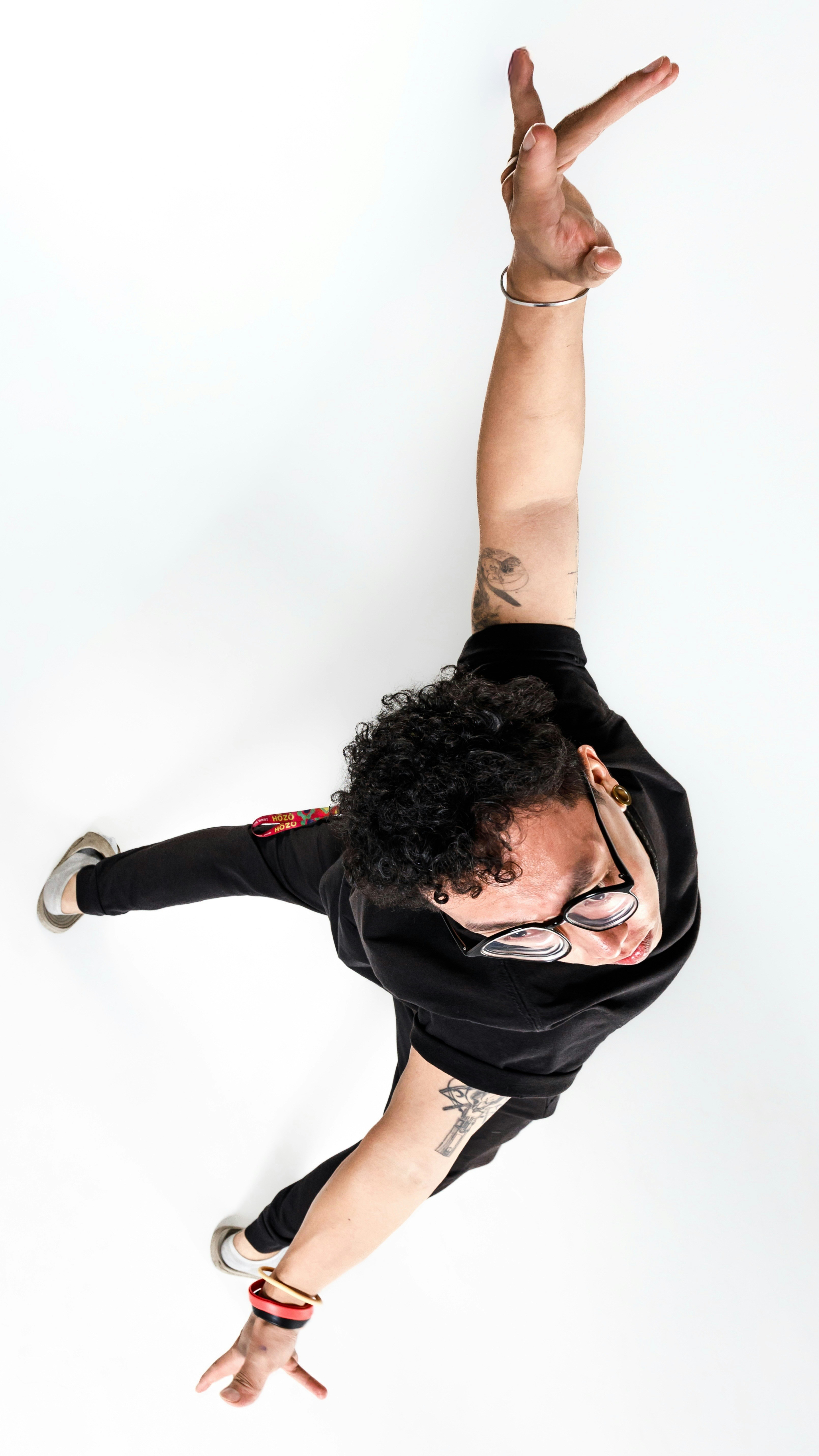 Man with curly hair dancing on white background