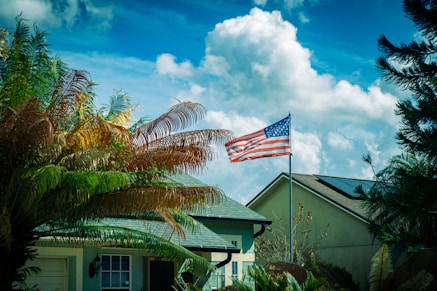 American flag waves proudly over suburban homes