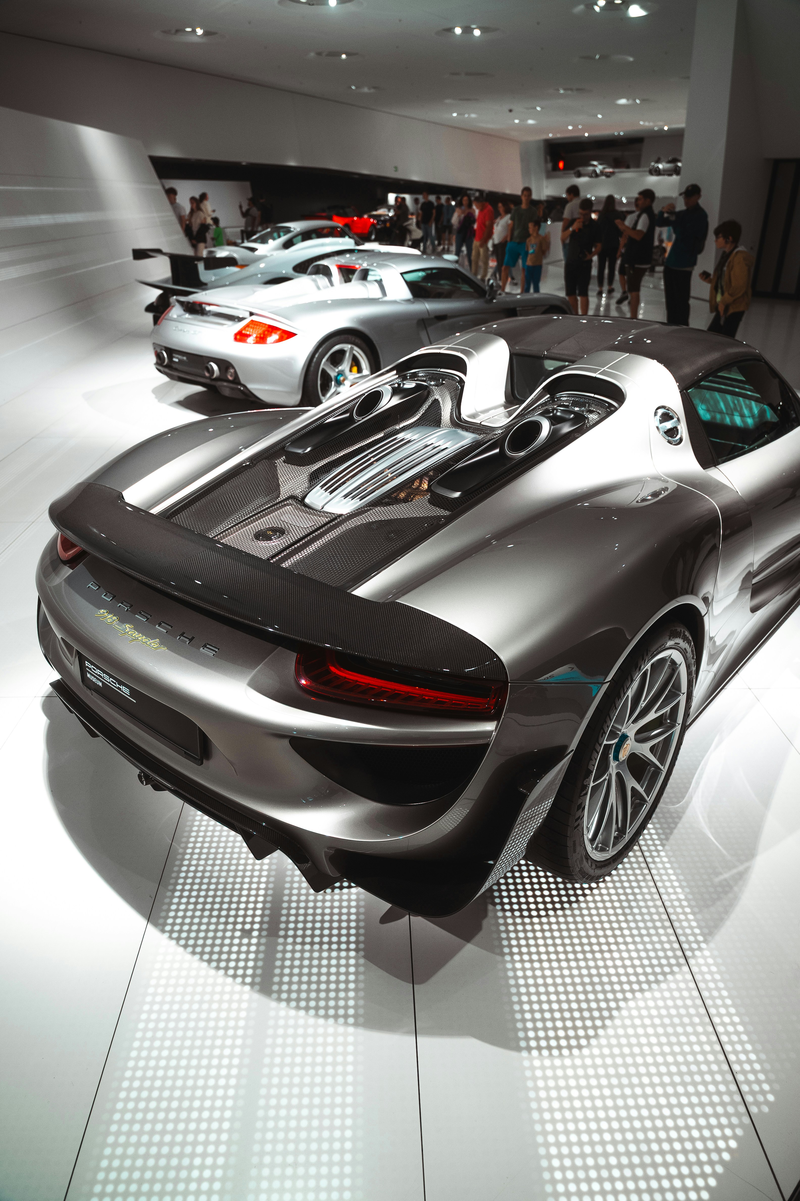 Sleek sports cars displayed in a modern showroom.
