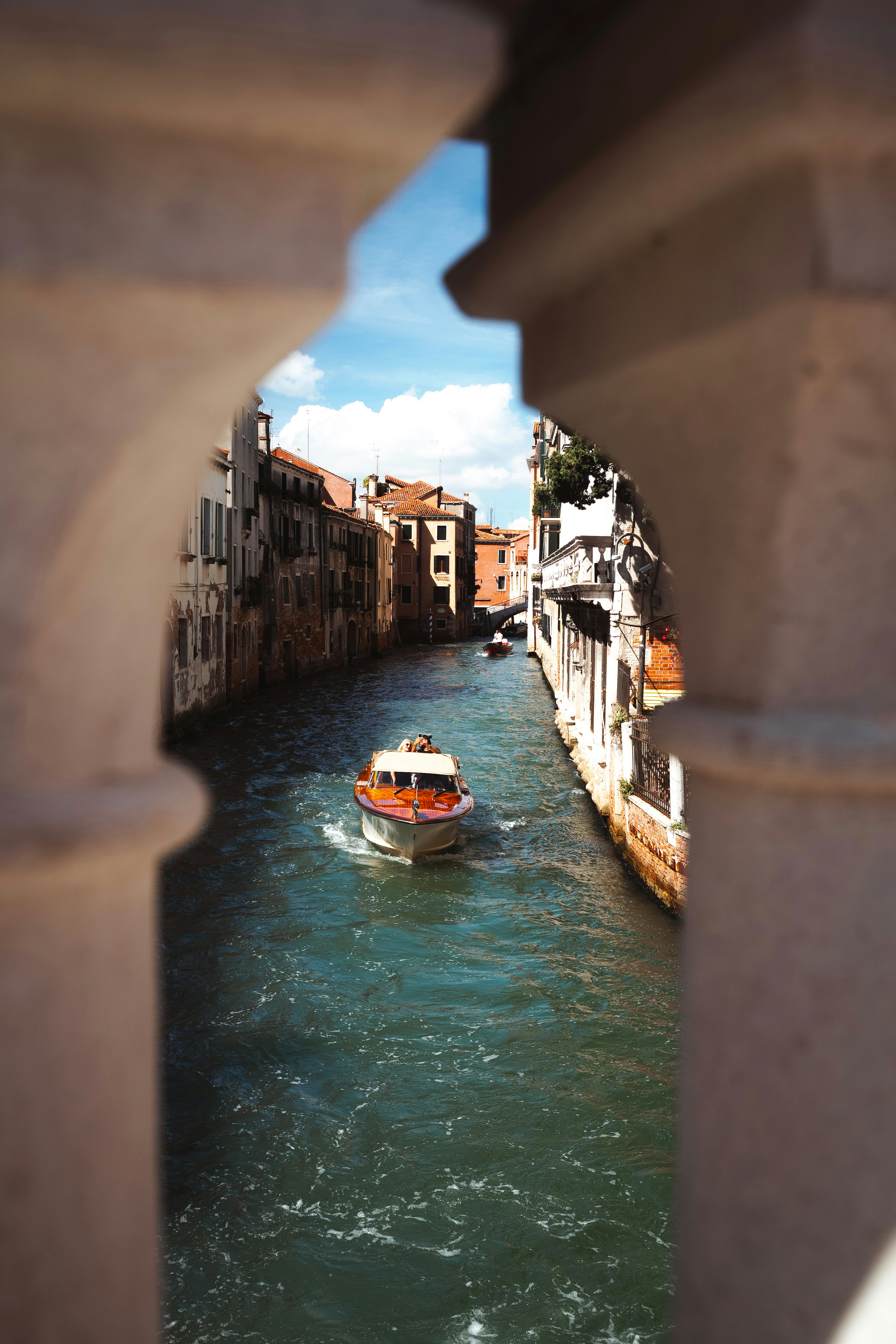 Boat on a canal in venice with old buildings.