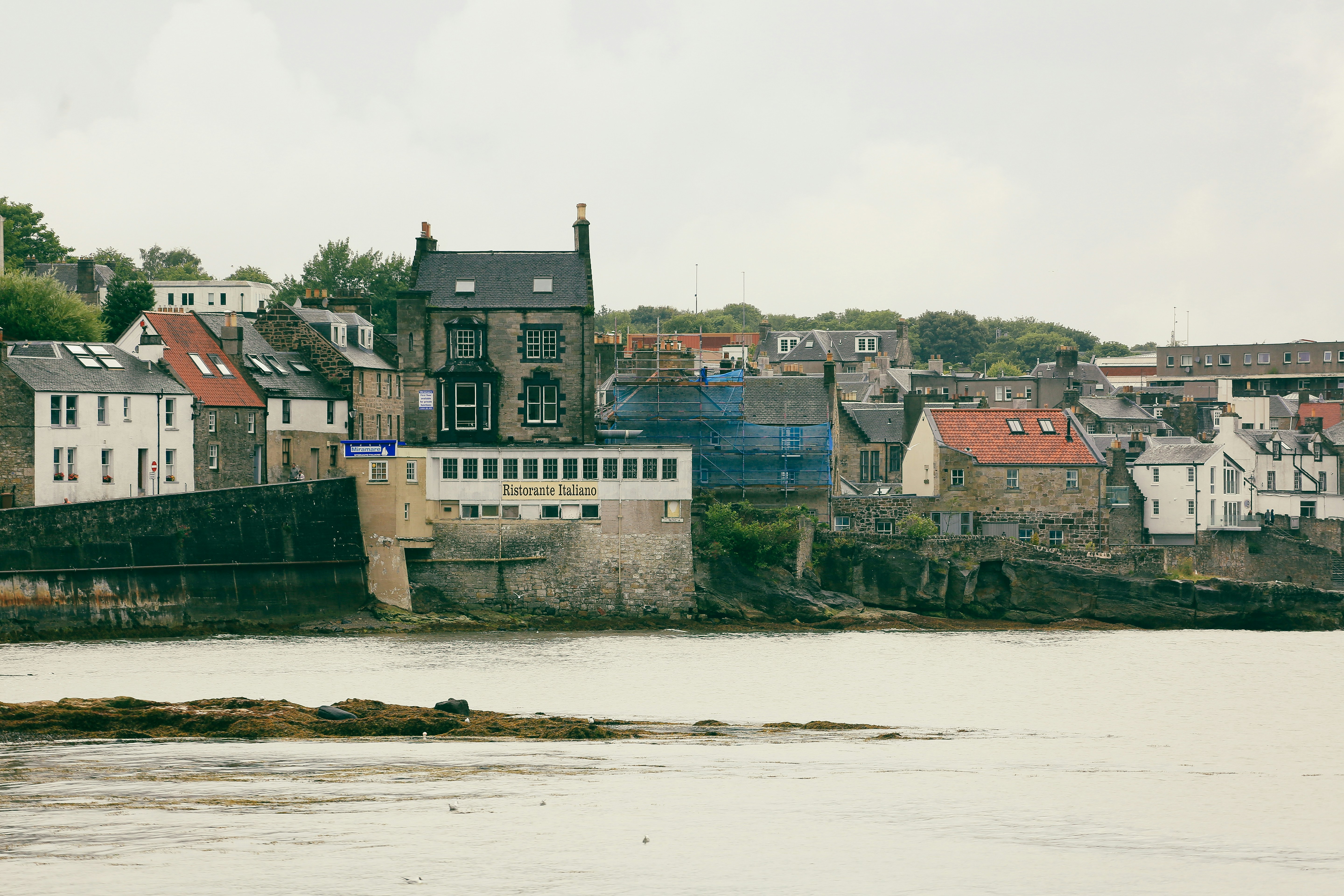 Coastal town with stone buildings and a harbor