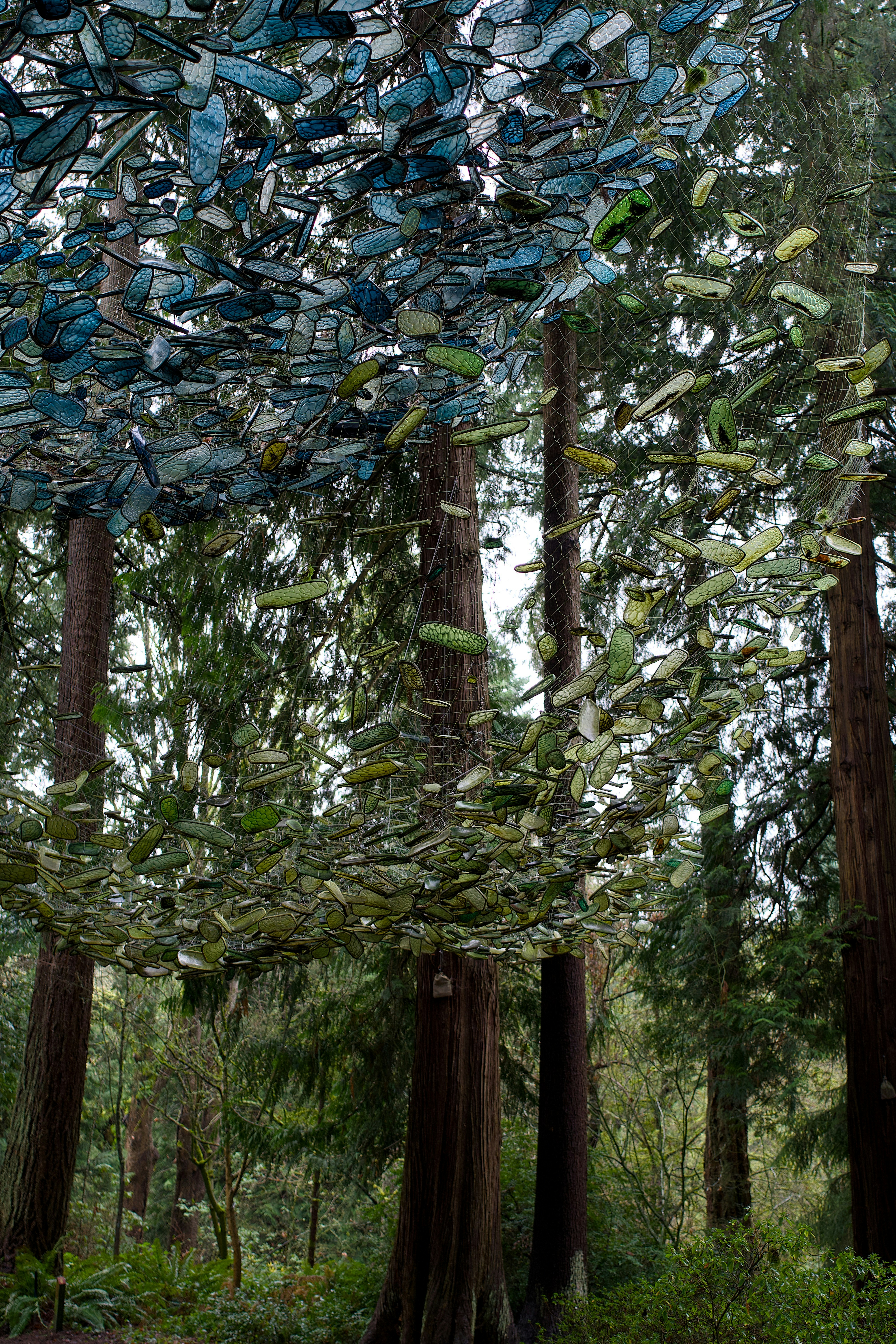 Circular art installation made of blue and green glass bottles. photo ...