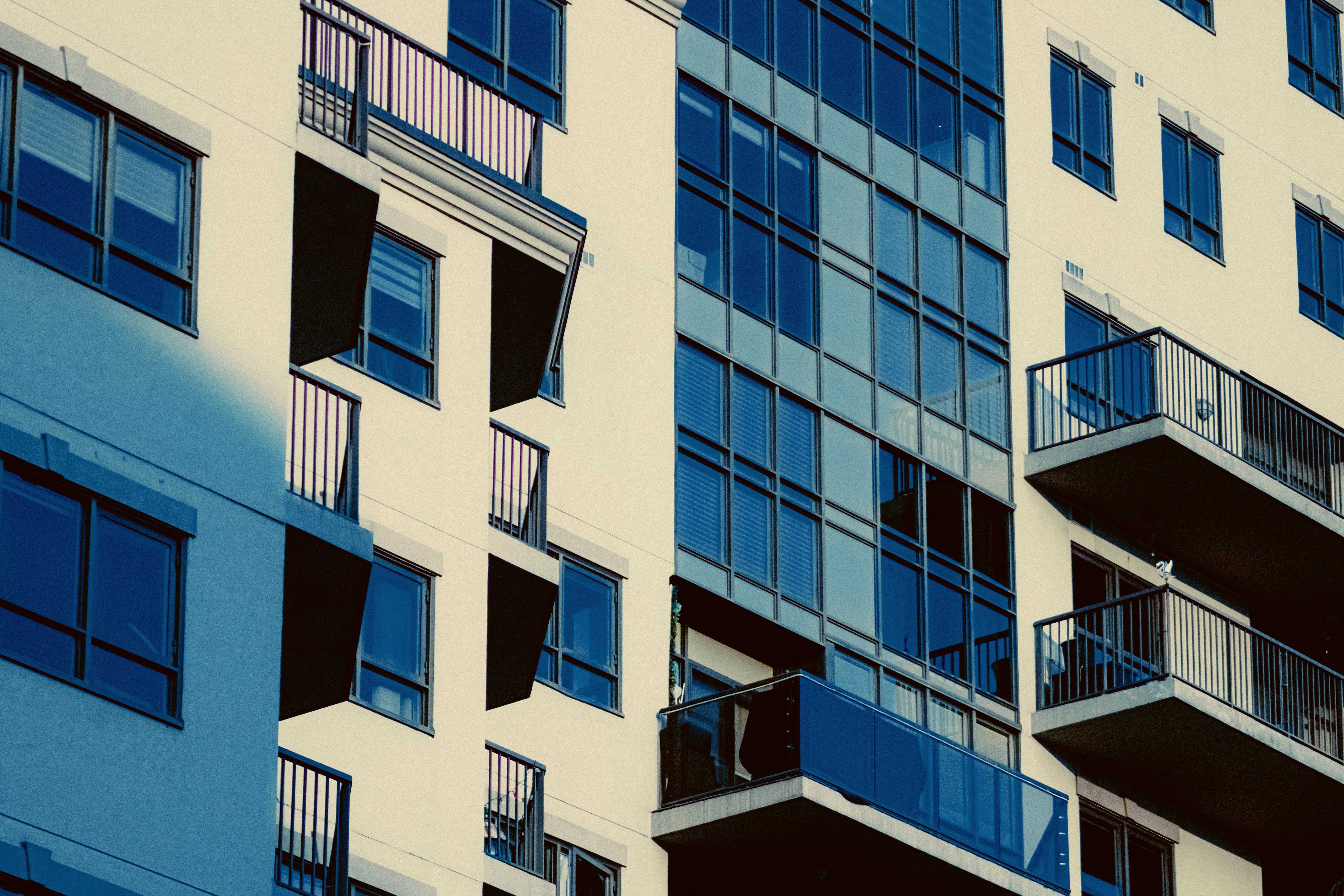 Modern apartment building with balconies and glass windows