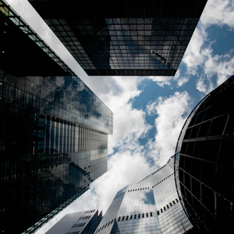 Modern skyscrapers reaching towards a cloudy sky