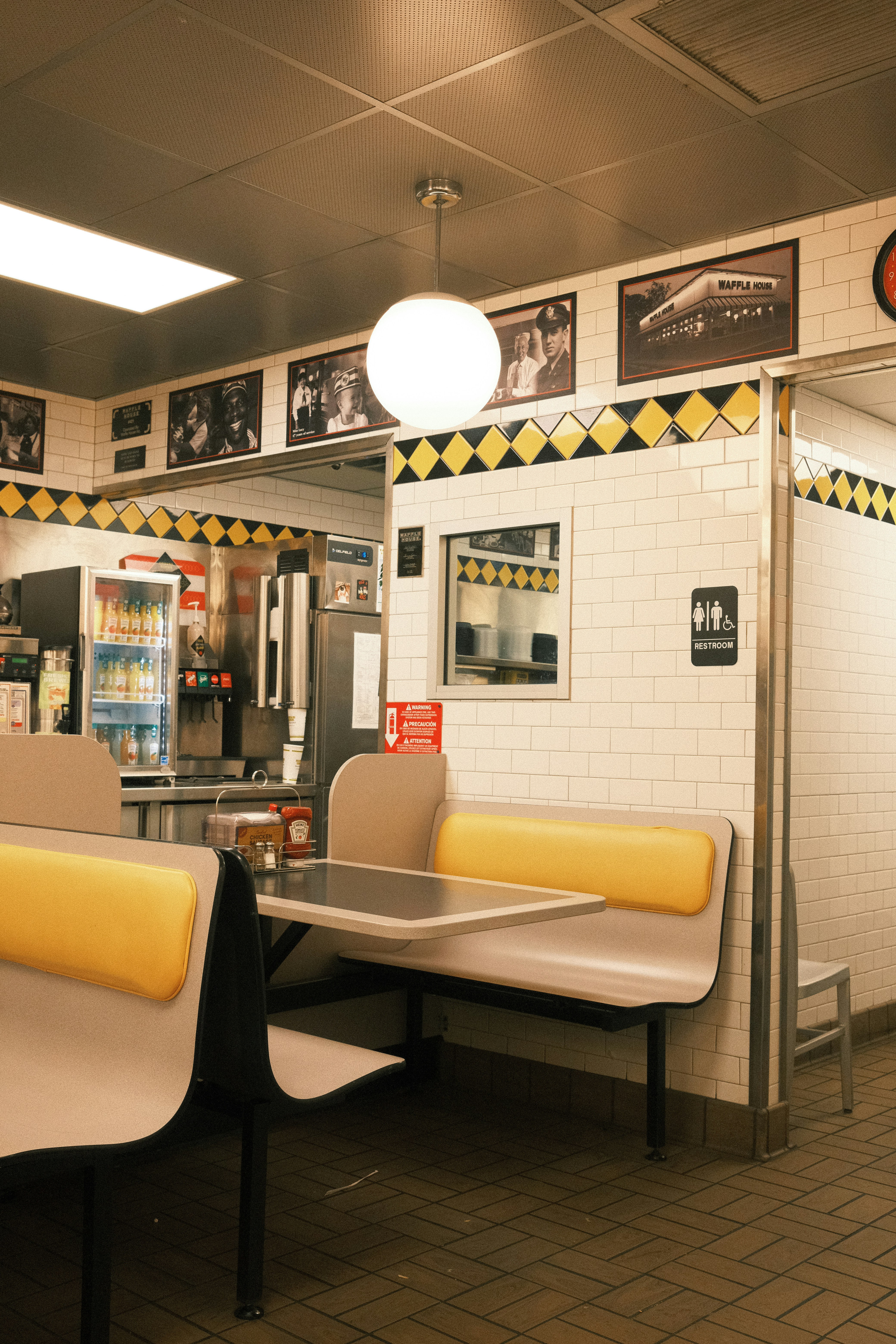 Diner booth and counter with framed pictures on wall