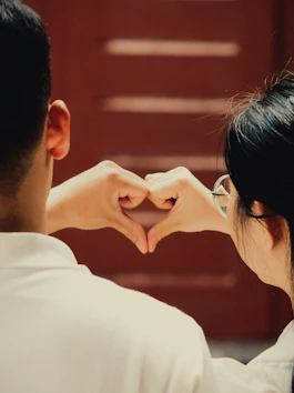 Couple making a heart shape with their hands