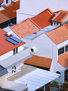 Tiled rooftops of residential houses under sunlight