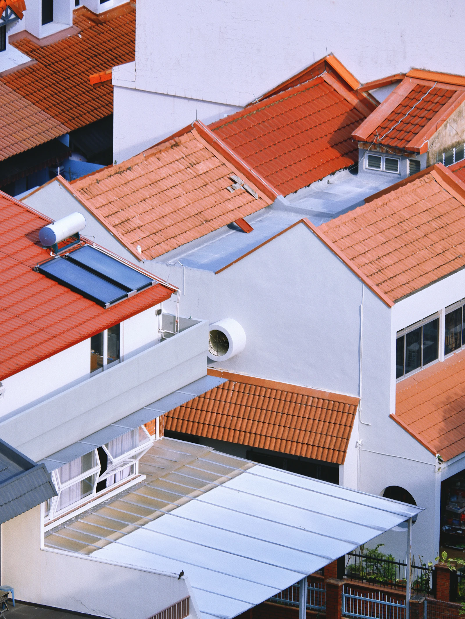 Clean red tile rooftops on a refined residential property