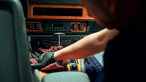 Mechanic working on car interior dashboard