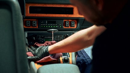 Mechanic working on car interior dashboard