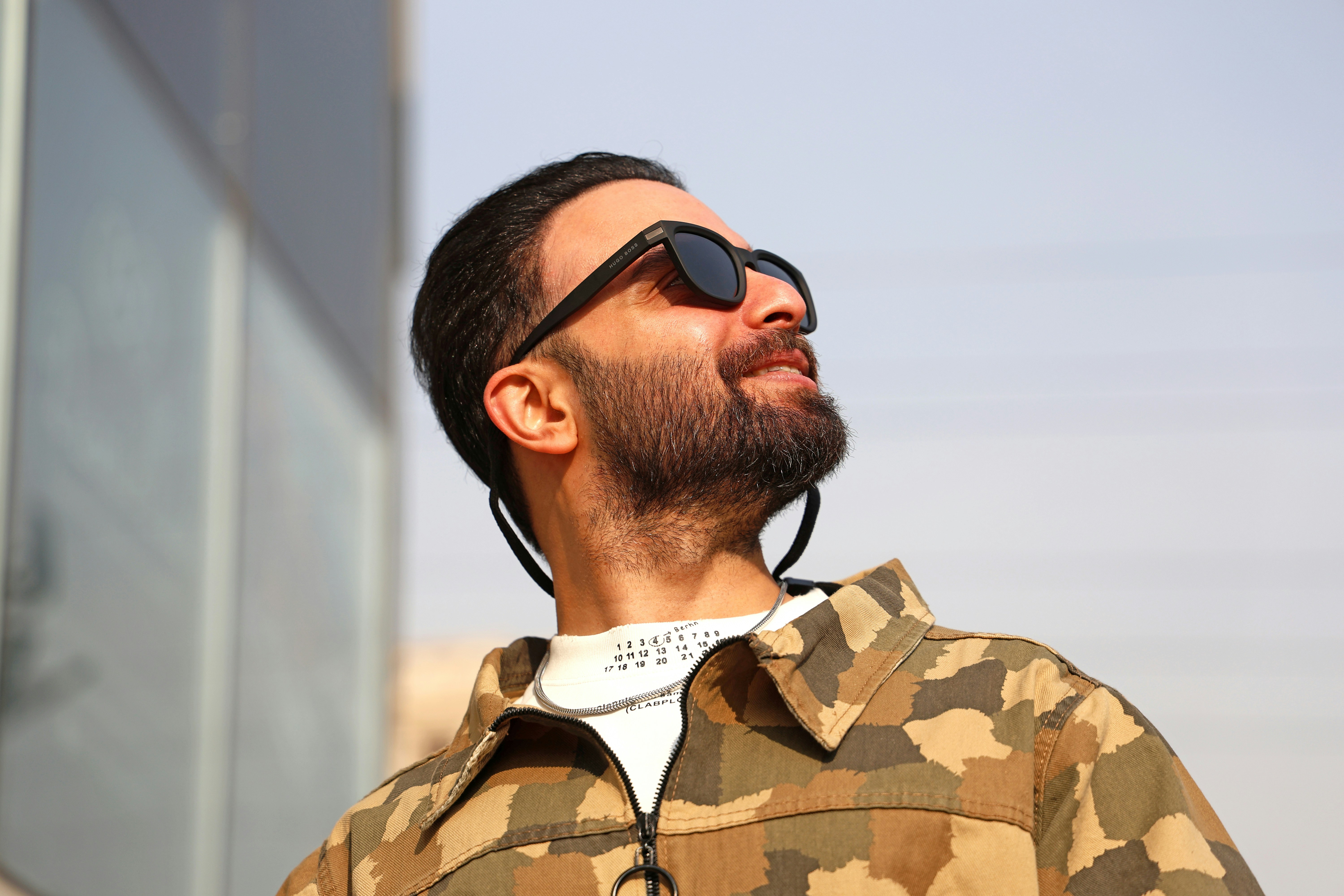 Man with beard wearing sunglasses and camouflage jacket