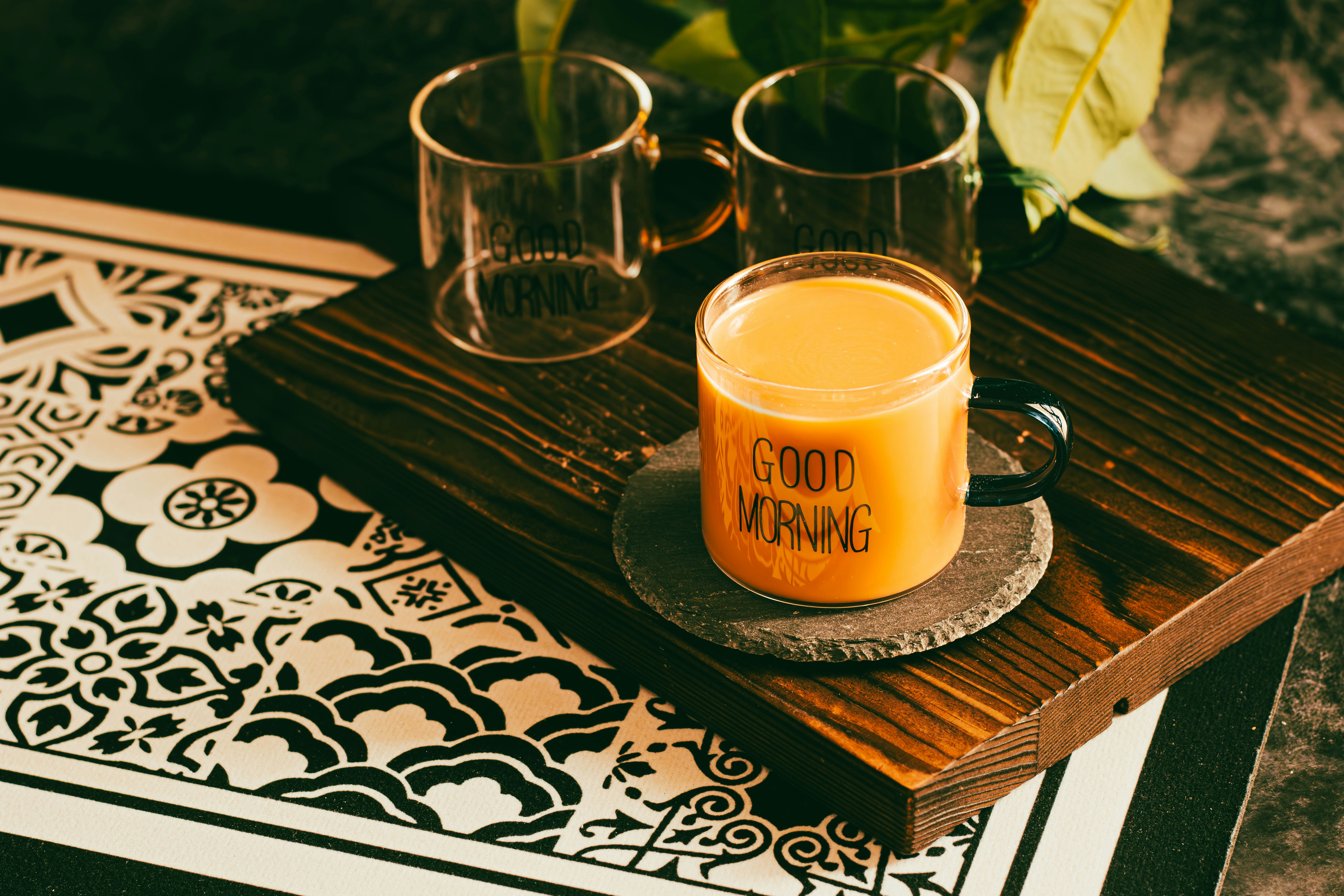 Orange beverage in a mug with "good vibes"
