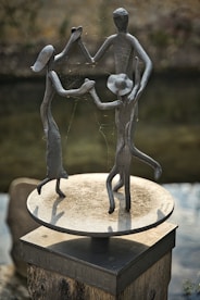 Sculpture of a family dancing on a platform.