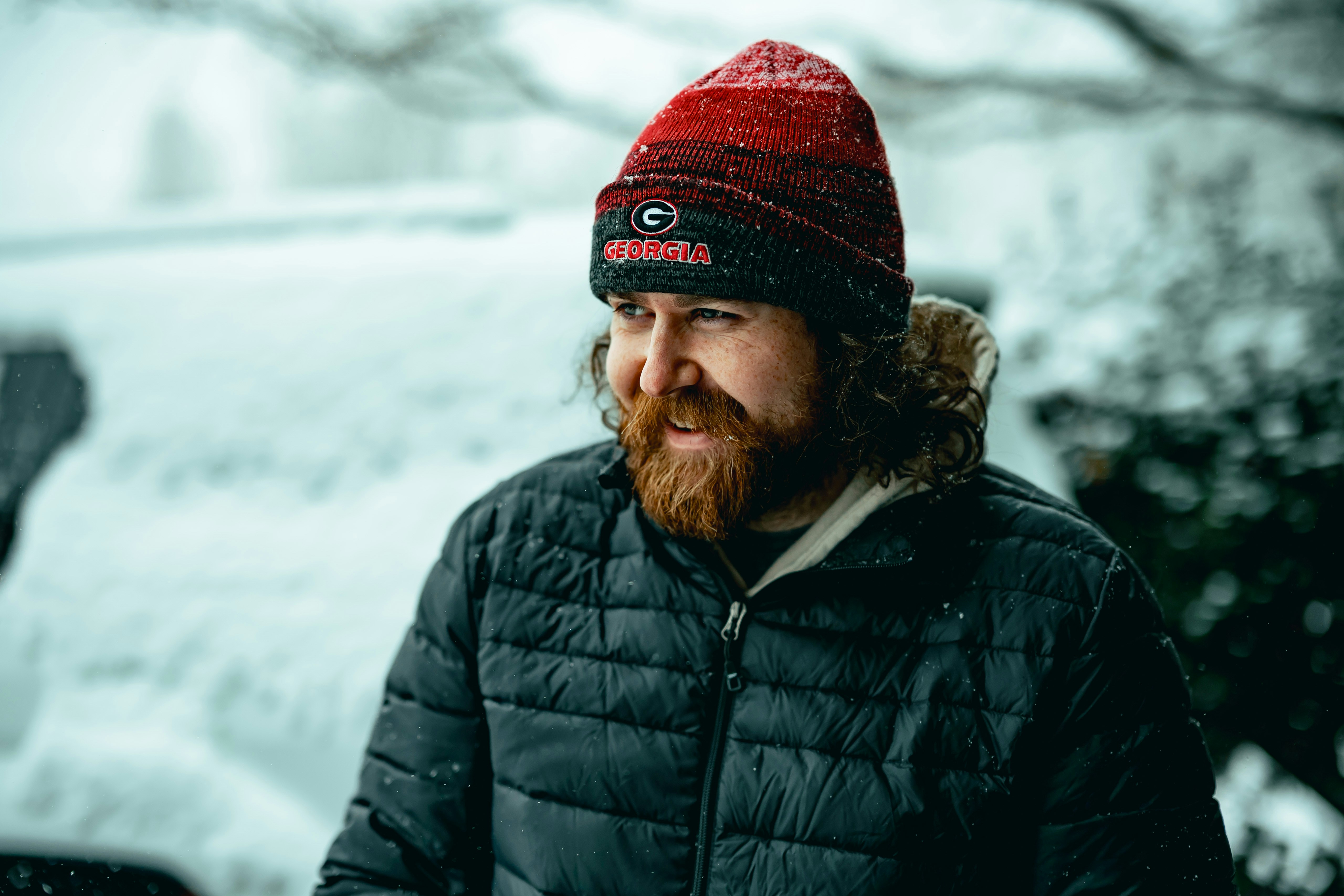 Man with beard wearing a beanie in the snow
