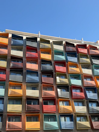 Colorful balconies on a modern building under blue sky
