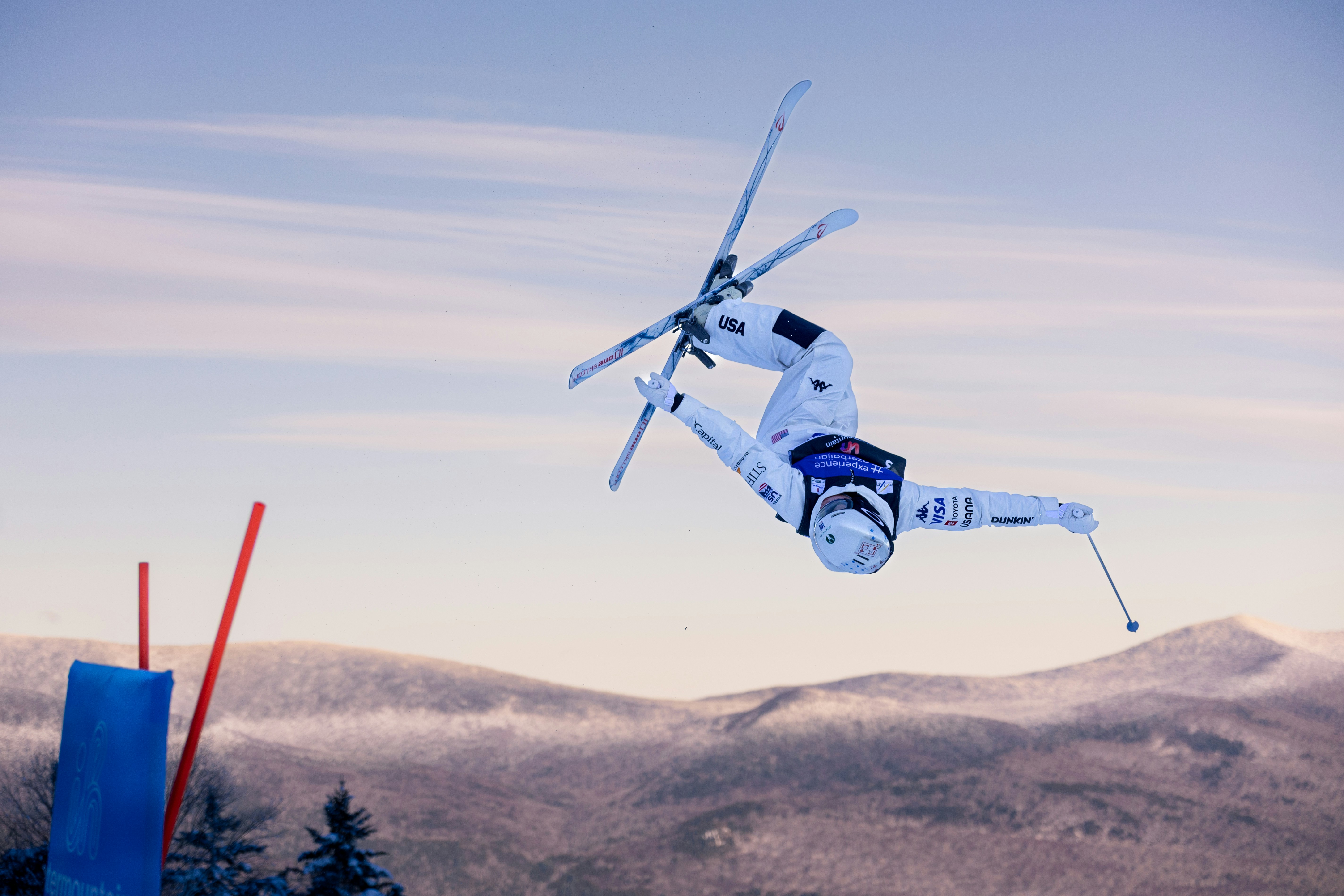 A freestyle skier performs a mid-air flip during a competition.