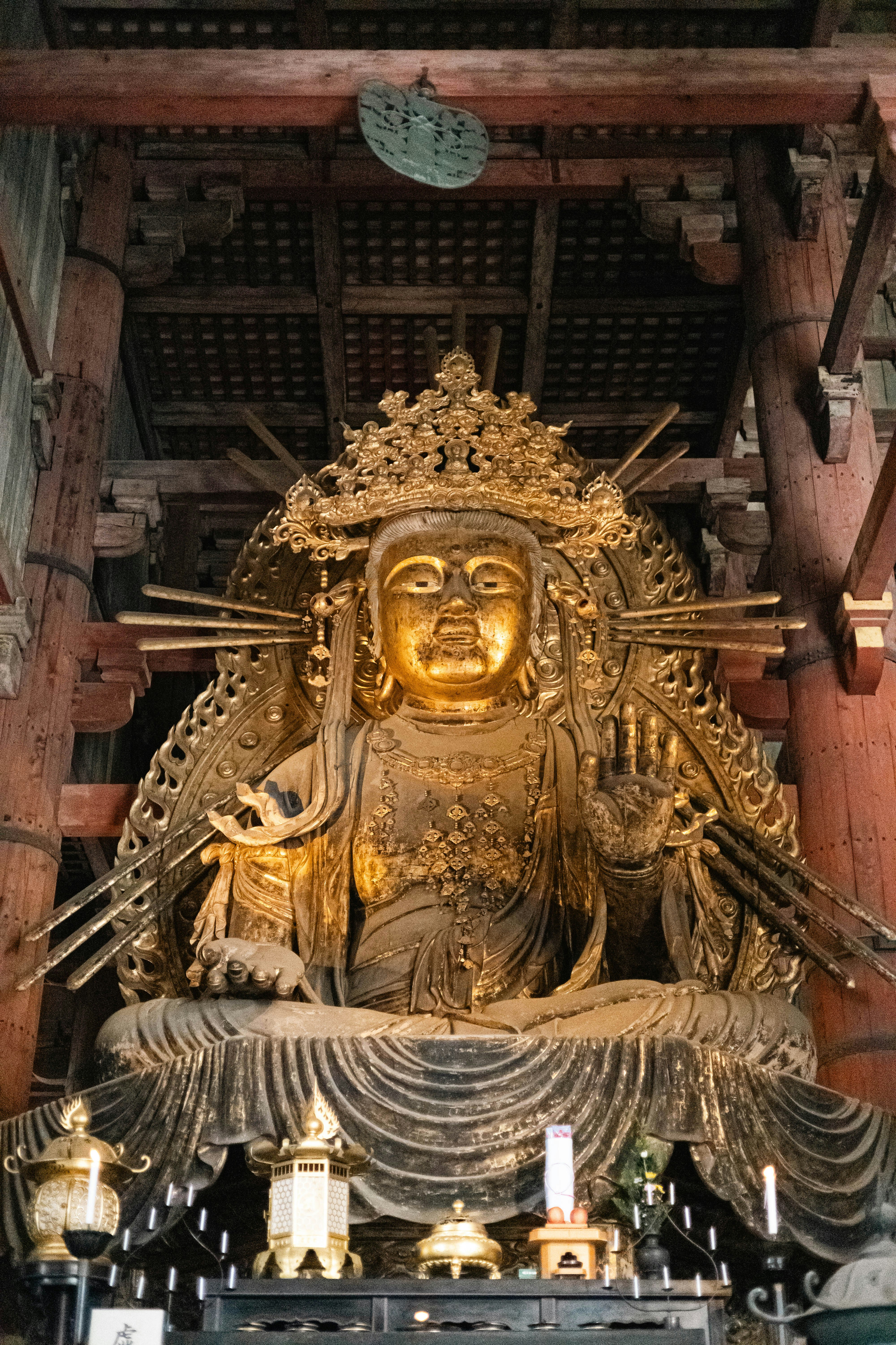 Golden buddha statue inside a wooden temple structure.