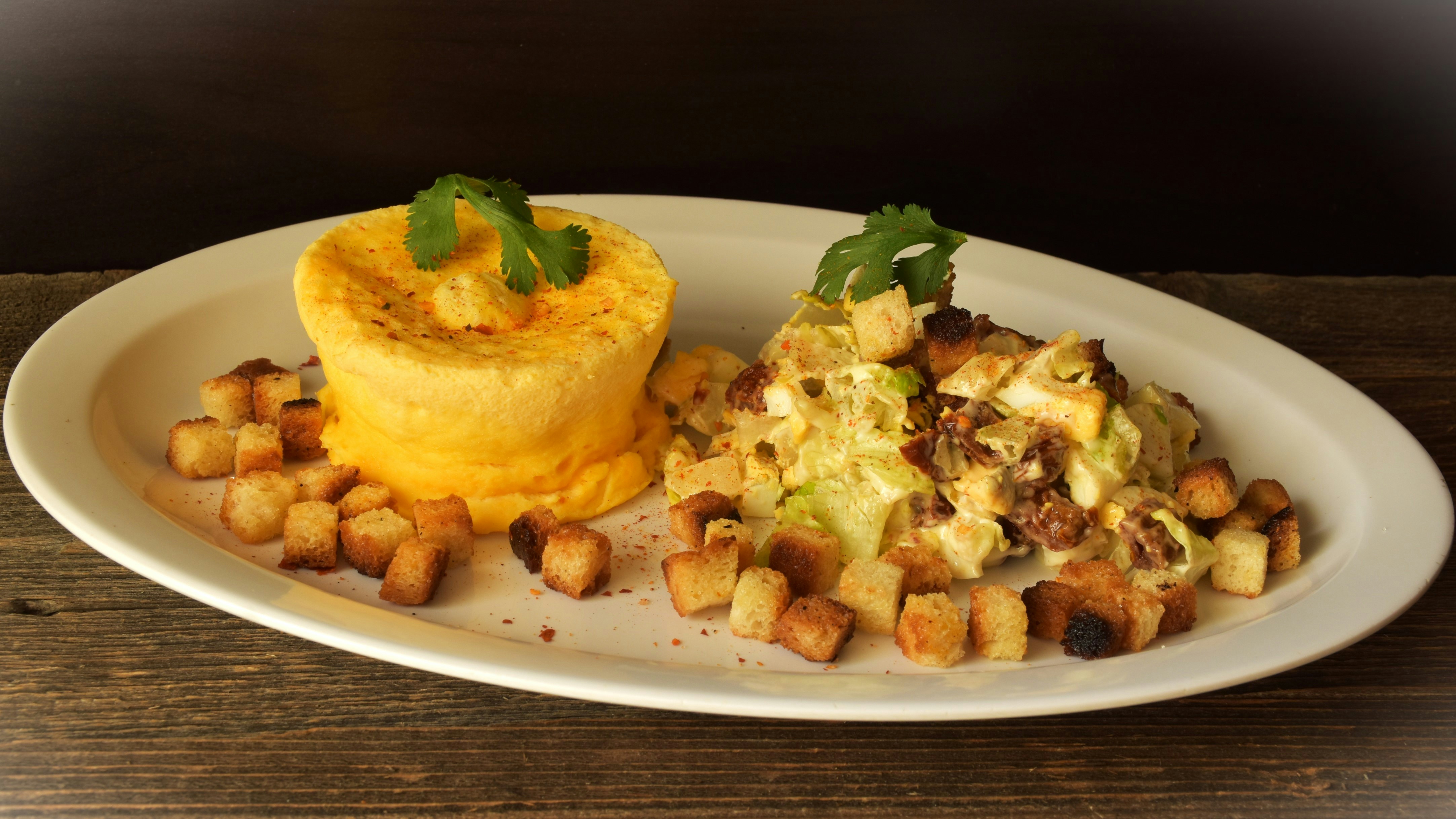 Savory souffle with salad and croutons on a plate