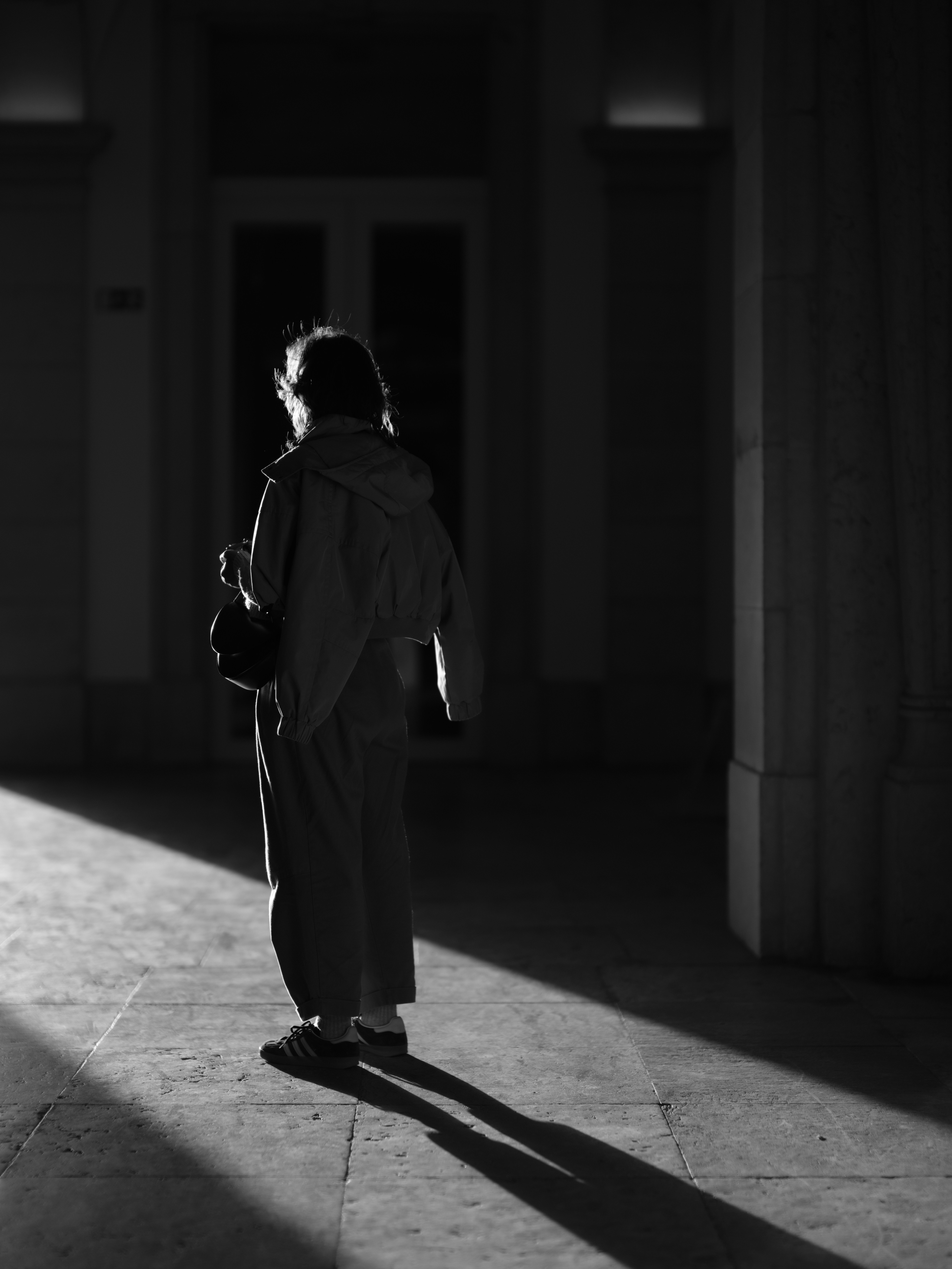 A person stands in a beam of light.