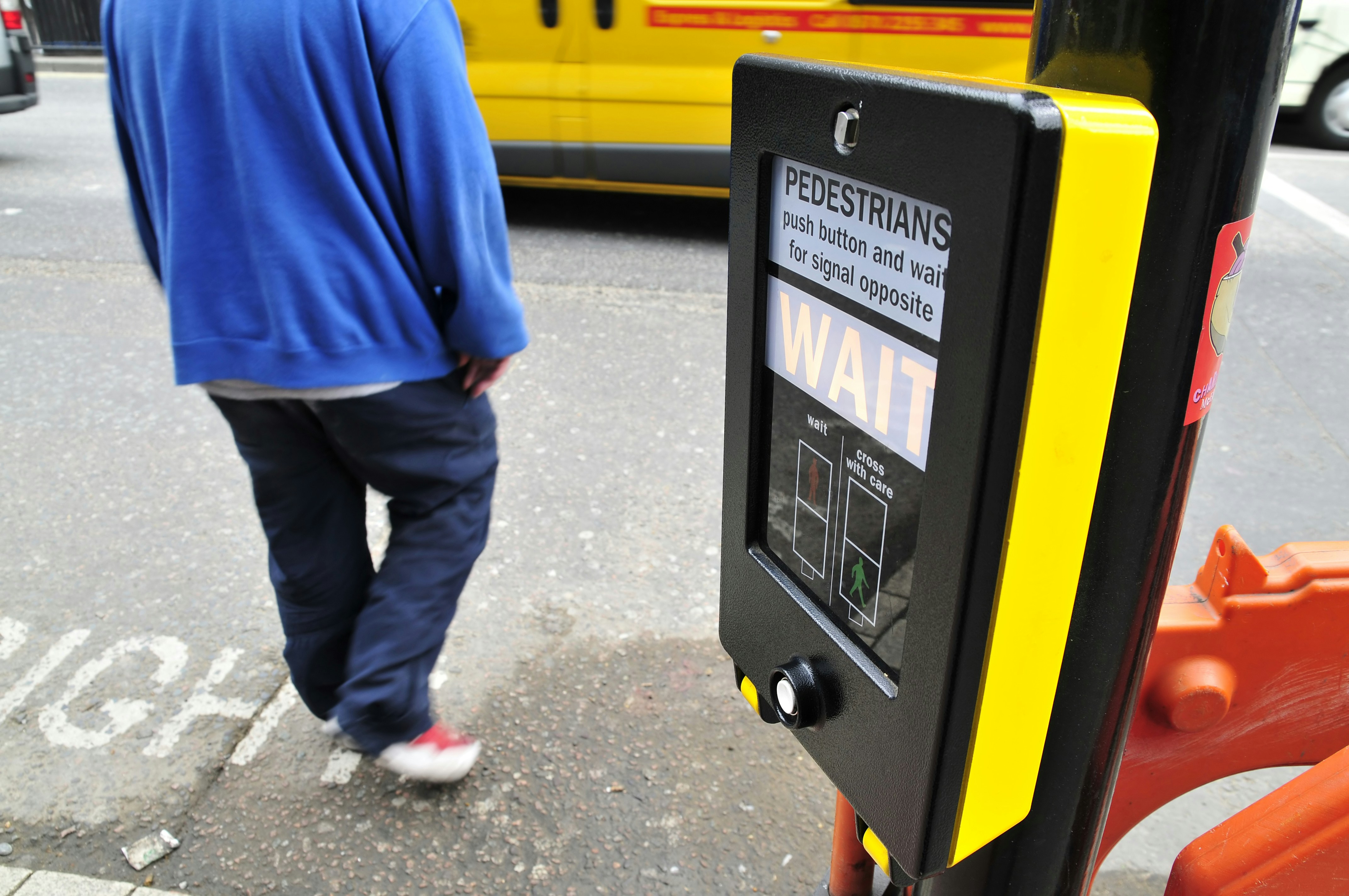Person waiting at a pedestrian crossing signal