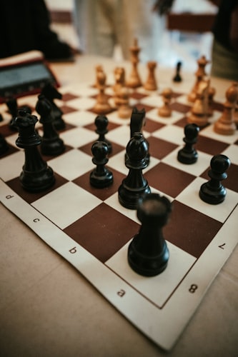 Chessboard with black and white pieces ready for game representing strategic puzzle thinking