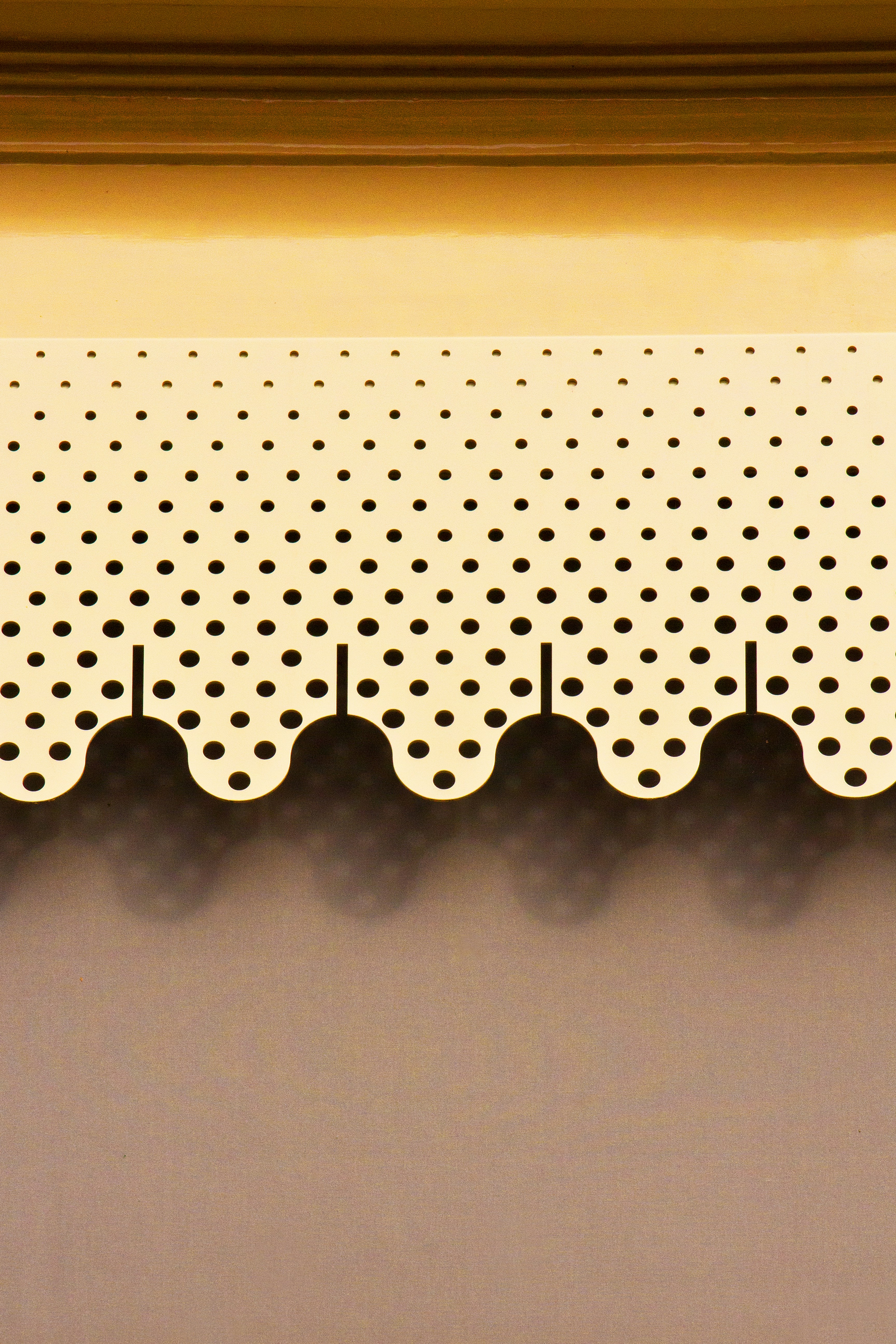 Decorative yellow scallop trim with black polka dots