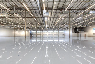 Shiny warehouse floor with overhead lights and ceiling
