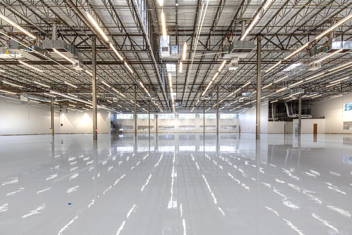 Interior of an industrial warehouse with modern ceiling lighting and polished floor