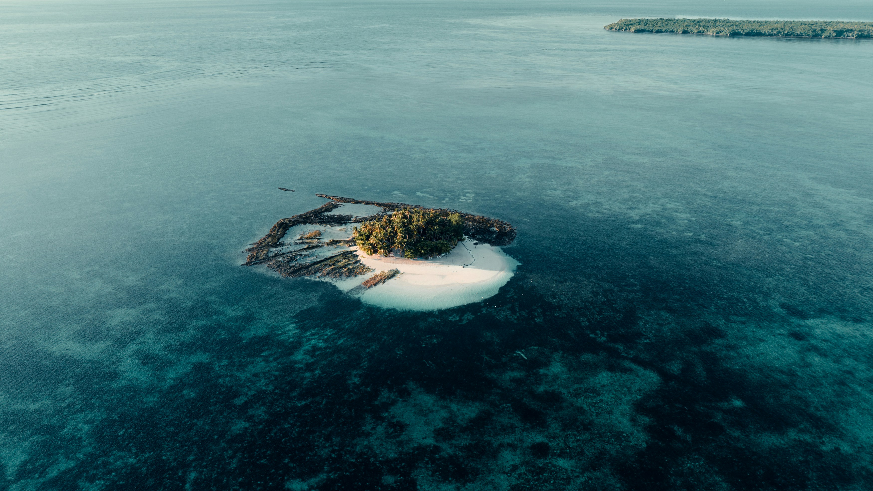 Small tropical island surrounded by clear blue water