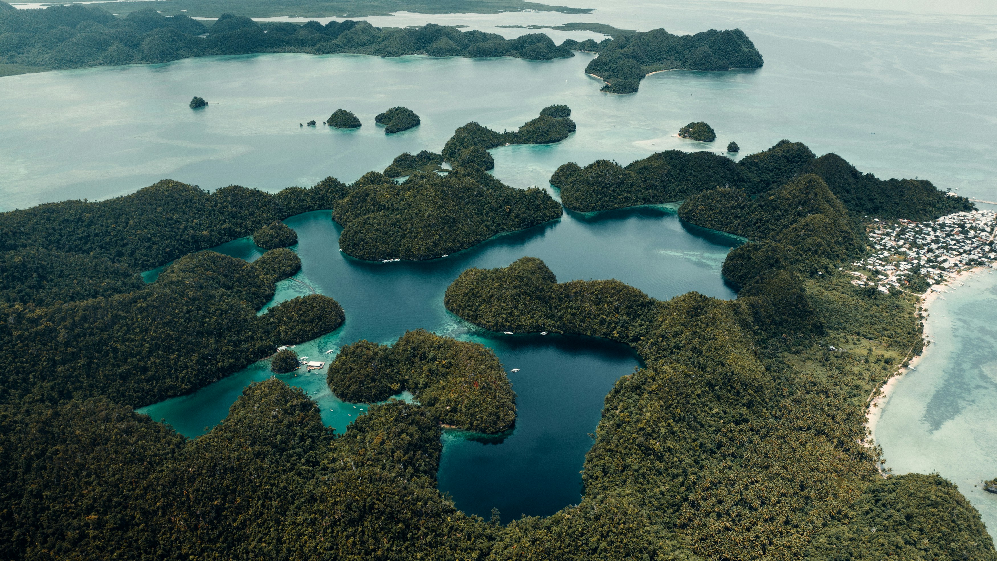 Lush green islands dotting a clear blue ocean.